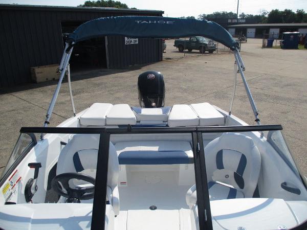2023 Tahoe 185 S boat with canopy and seating, parked outdoors.