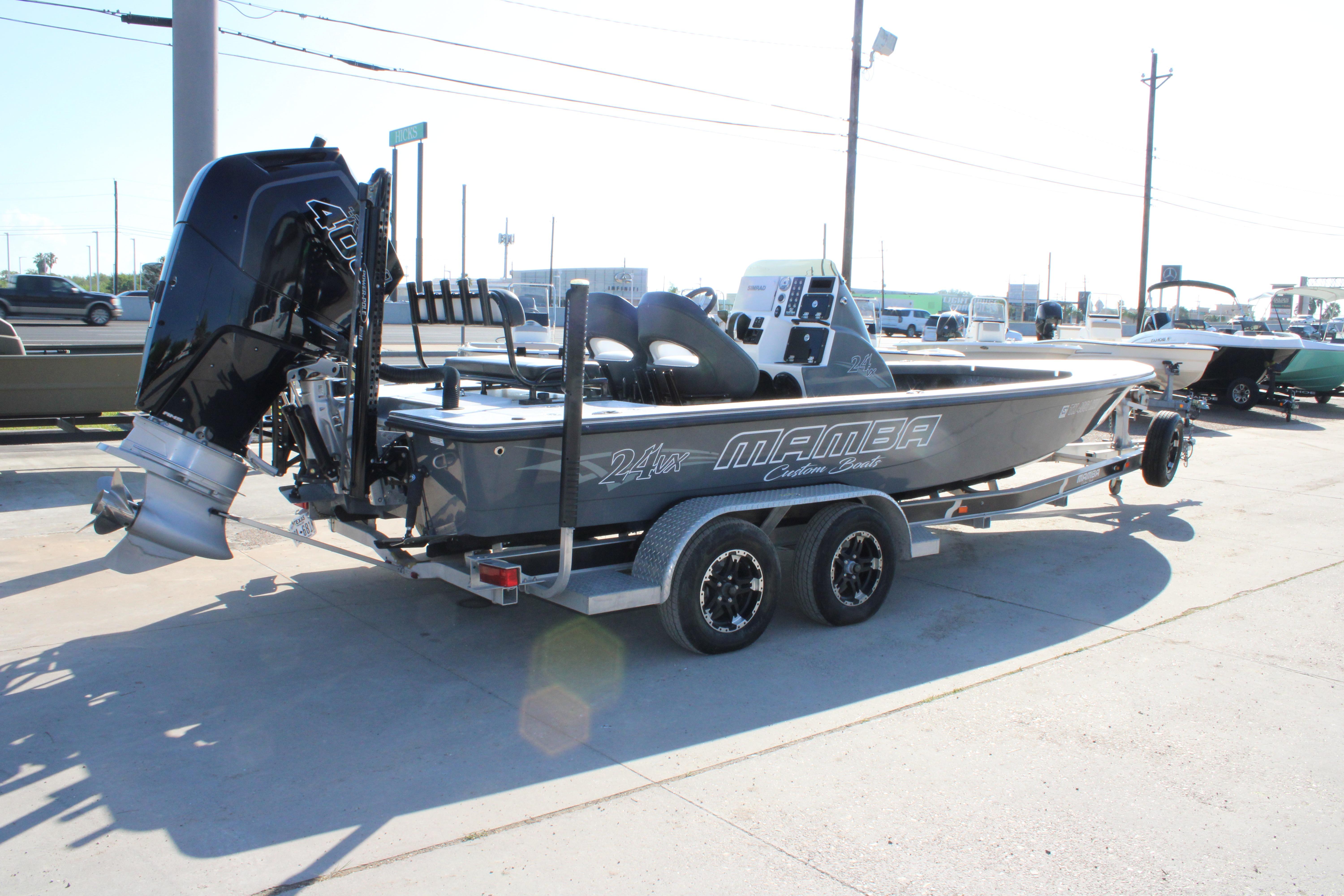2023 Mamba 24VX boat on trailer, featuring powerful outboard motor, parked outdoors.