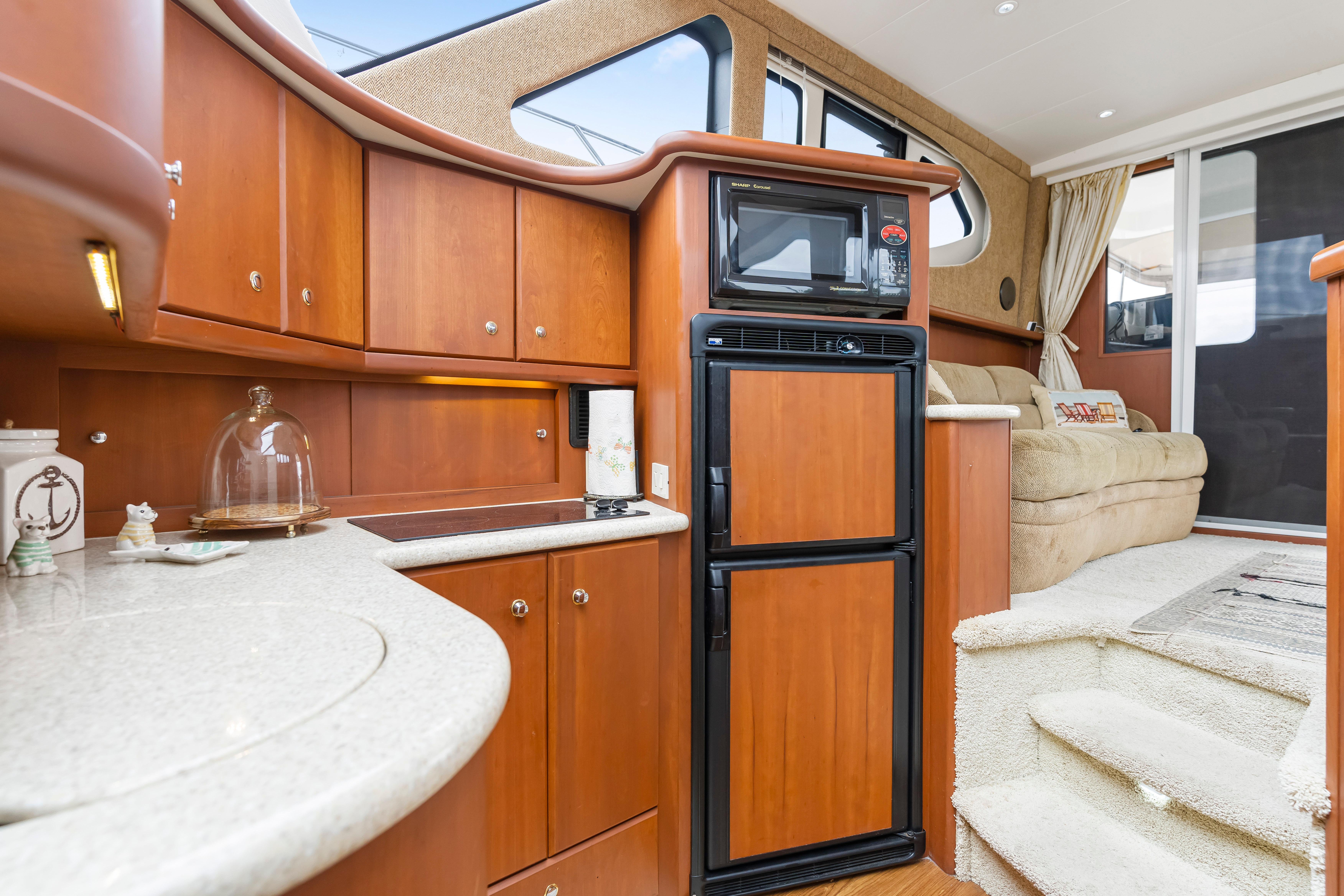 Interior of 2005 Silverton 34 Convertible yacht with kitchen and seating area.