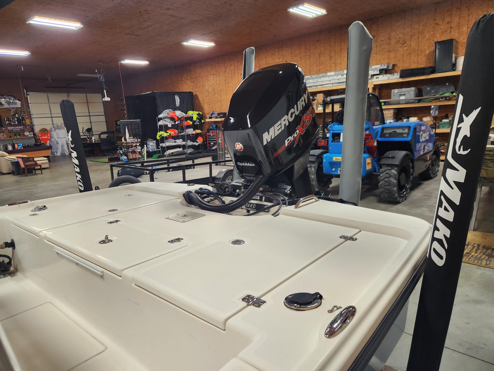 The image shows a 2014 Mako 21 LTS boat in a storage facility.
