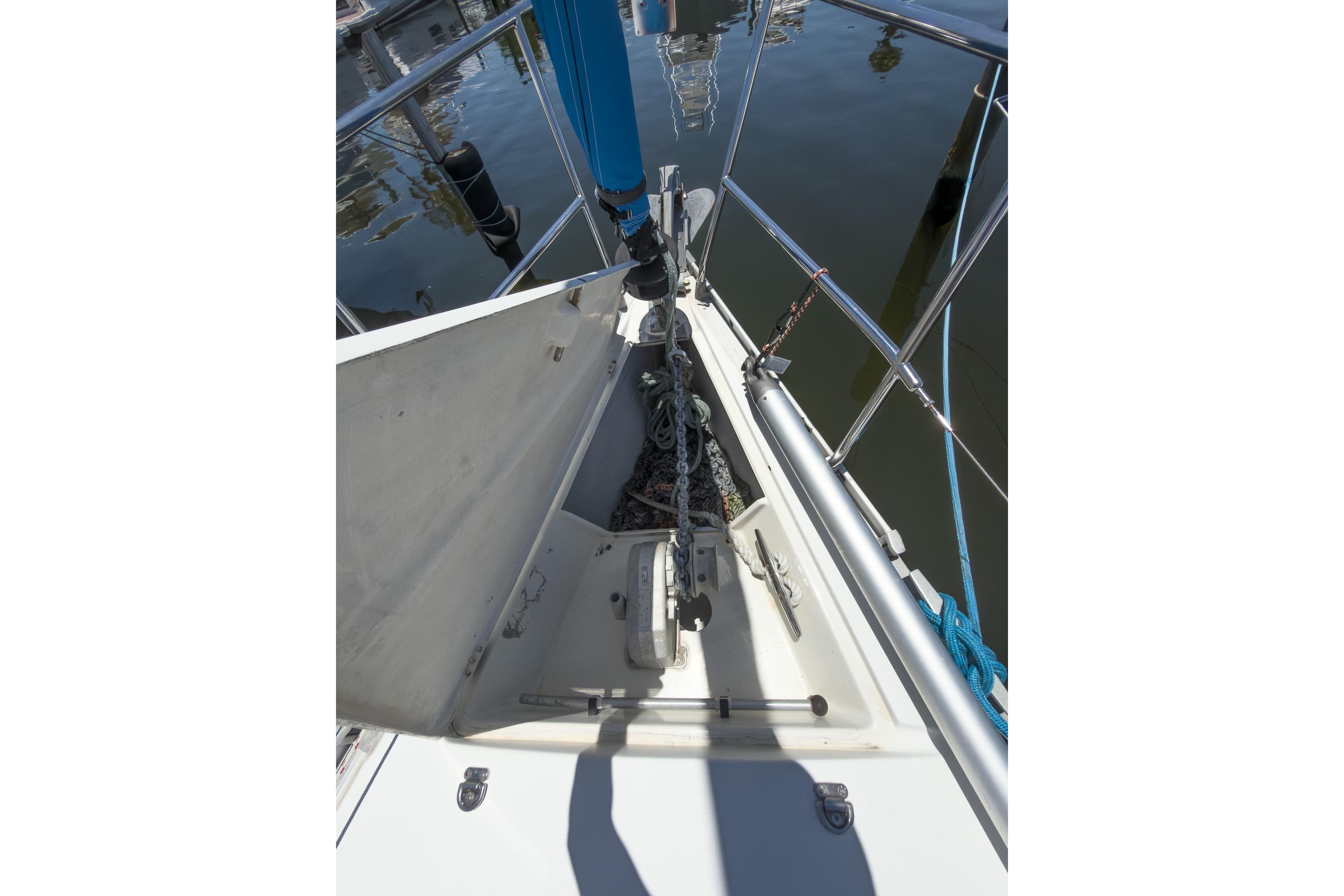 Bow of 1993 Beneteau First 38 s5 sailboat with anchor and chain storage.