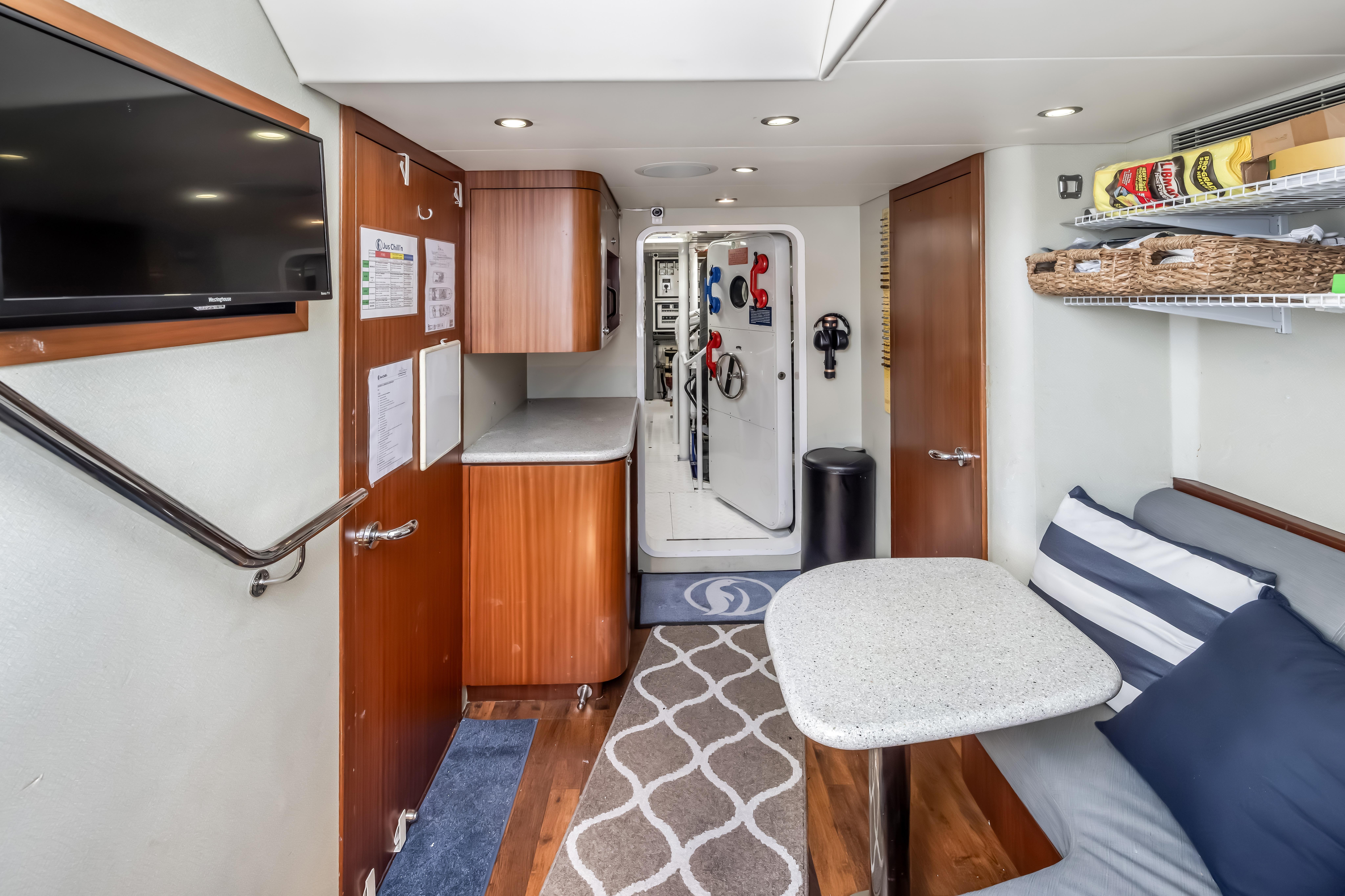 Interior of 2012 Cheoy Lee 84 Bravo yacht with cozy seating and modern amenities.