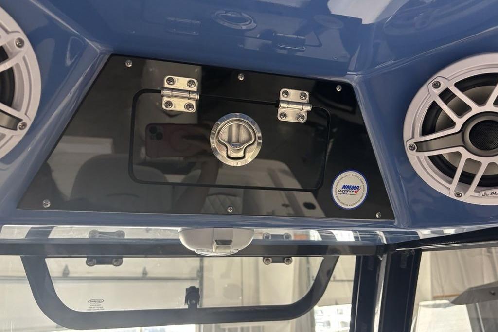 2026 Sportsman Masters 247 Bay Boat dashboard with speakers and storage compartment.
