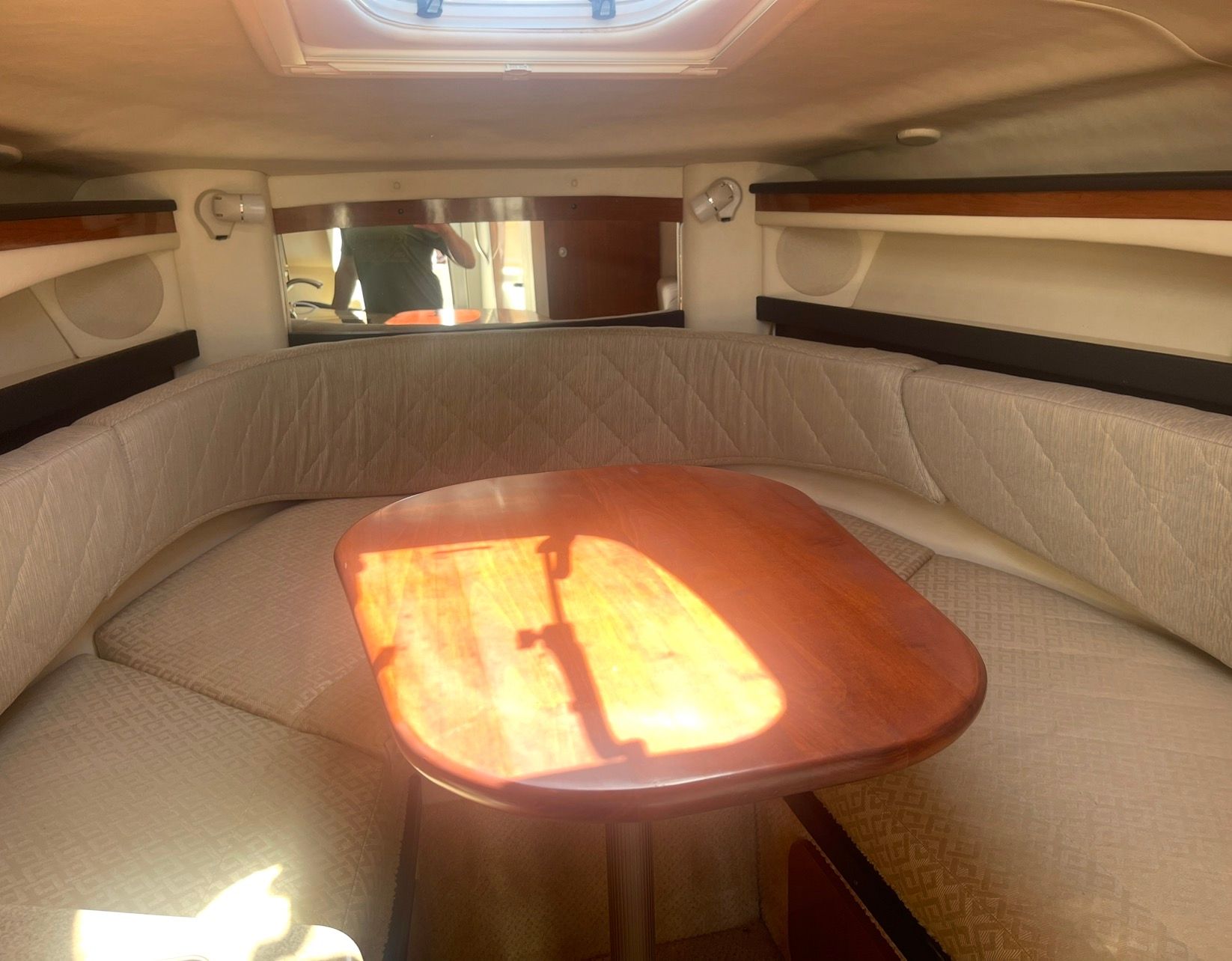 Interior of 2006 Sea Ray 270 Amberjack with table and seating area.