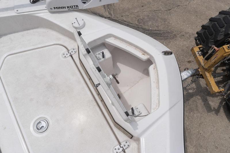 2023 Yamaha Boats 195 FSH Sport bow storage compartment with open hatch and Minn Kota trolling motor.