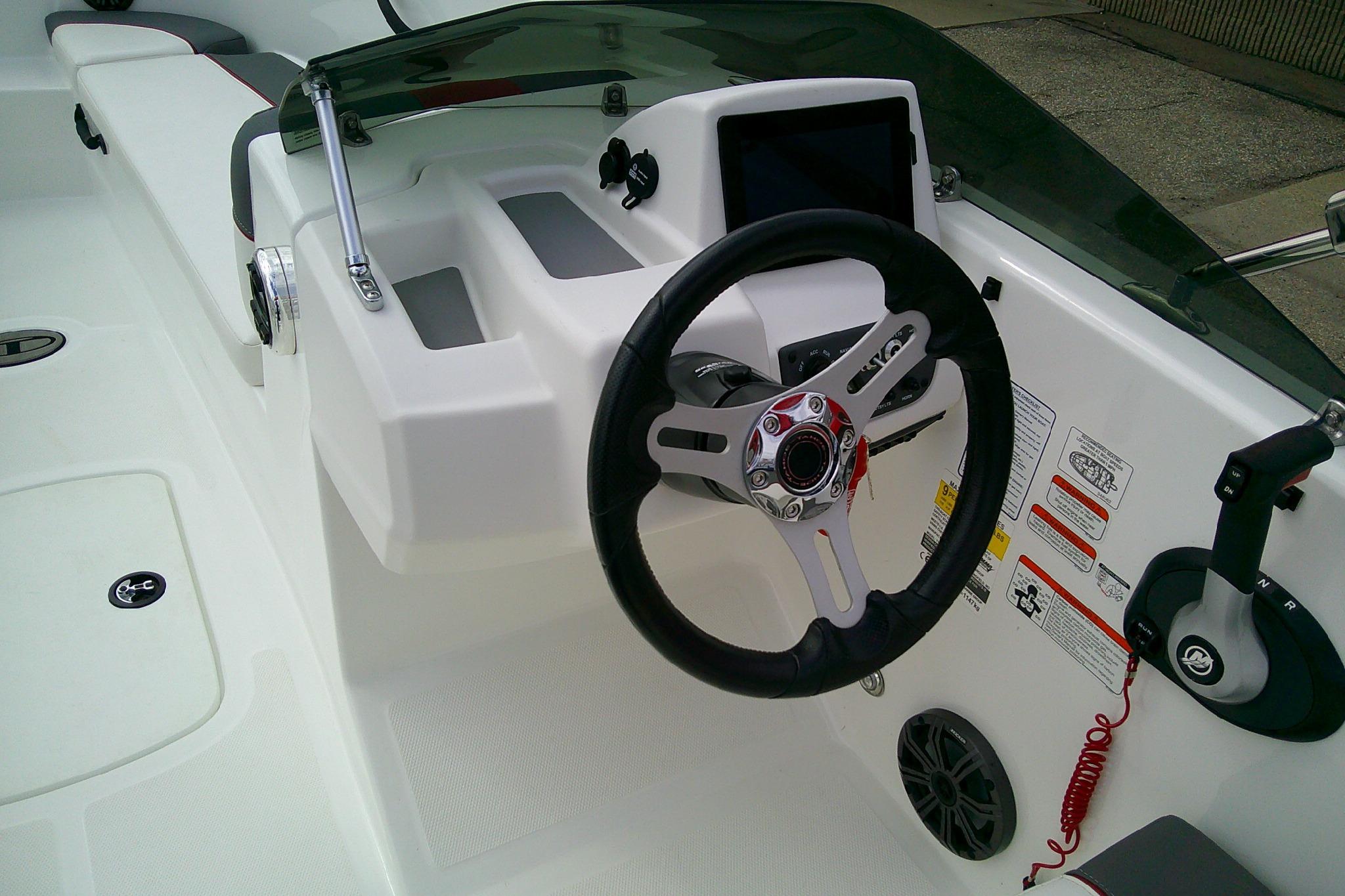 2024 Tahoe T18 boat dashboard with steering wheel and control panel.