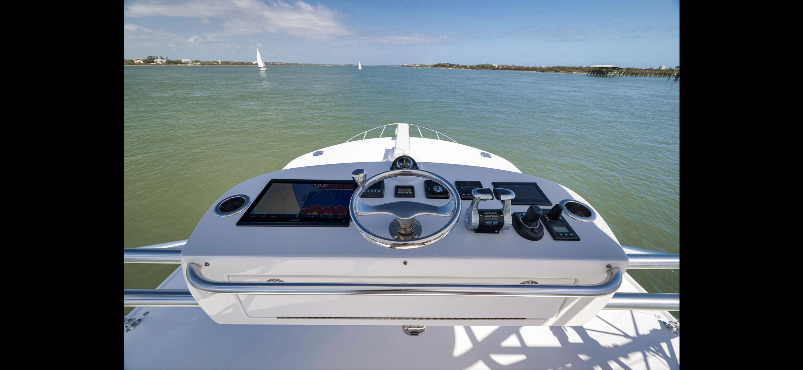 Helm of 2022 Mag Bay 42 Express on calm waters.