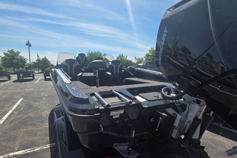 2026 Nitro ZV21 boat with Mercury engine in parking lot under clear sky.