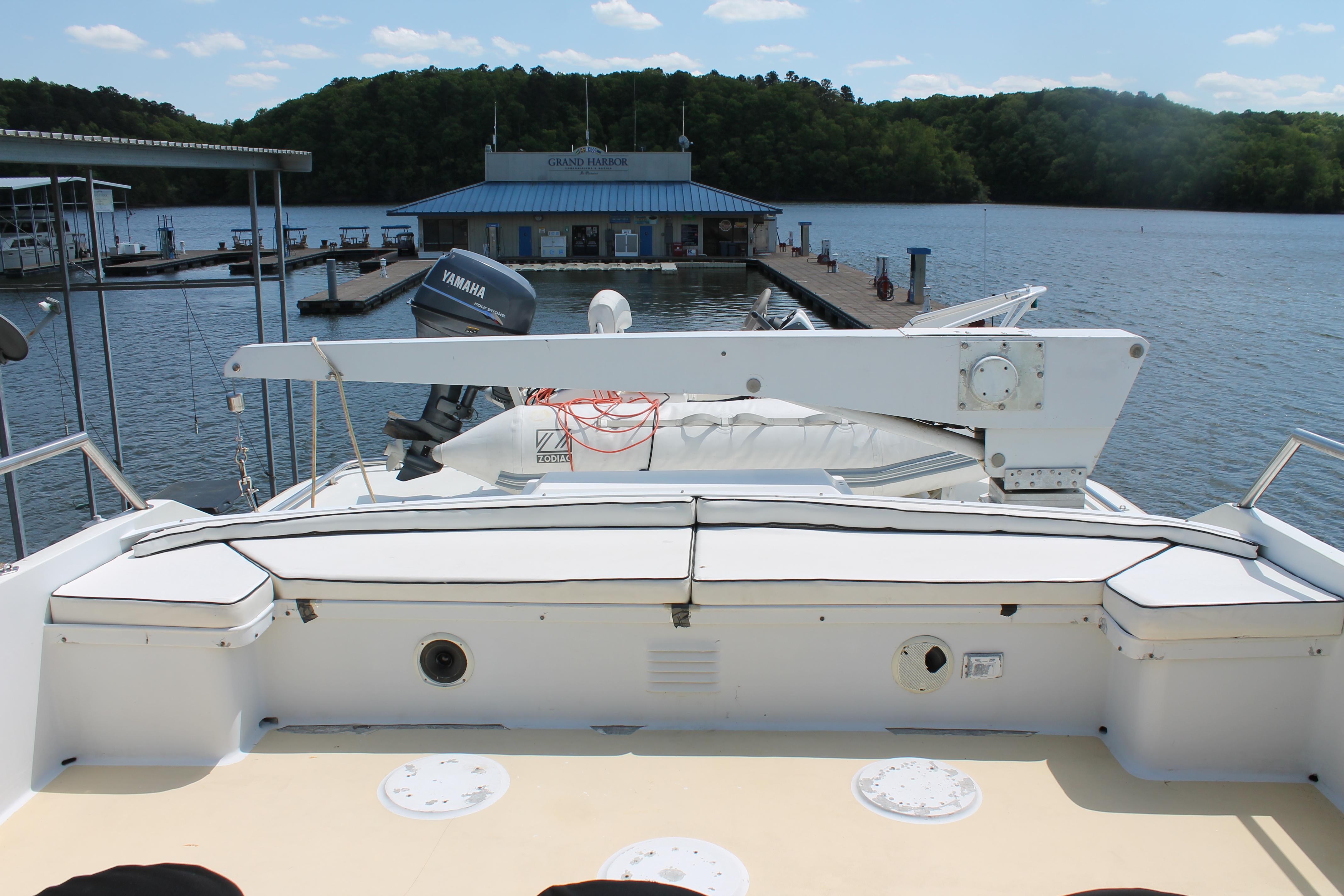 1984 Broward CPMY yacht docked with scenic water view.