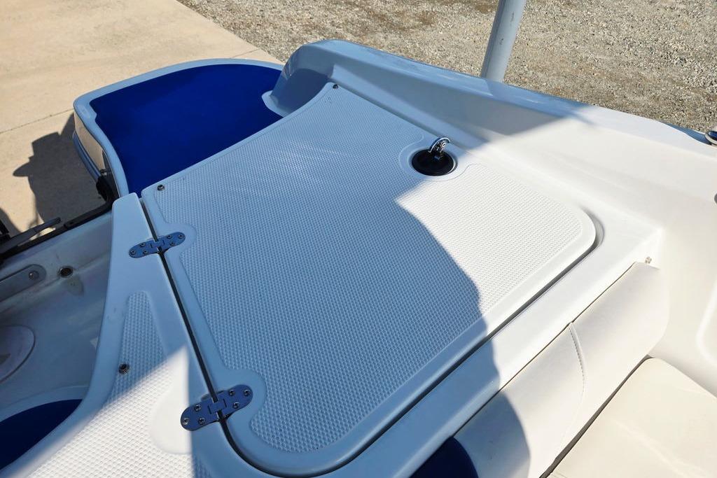 2018 Tahoe 450 TS boat deck with blue and white seating, featuring a storage compartment.