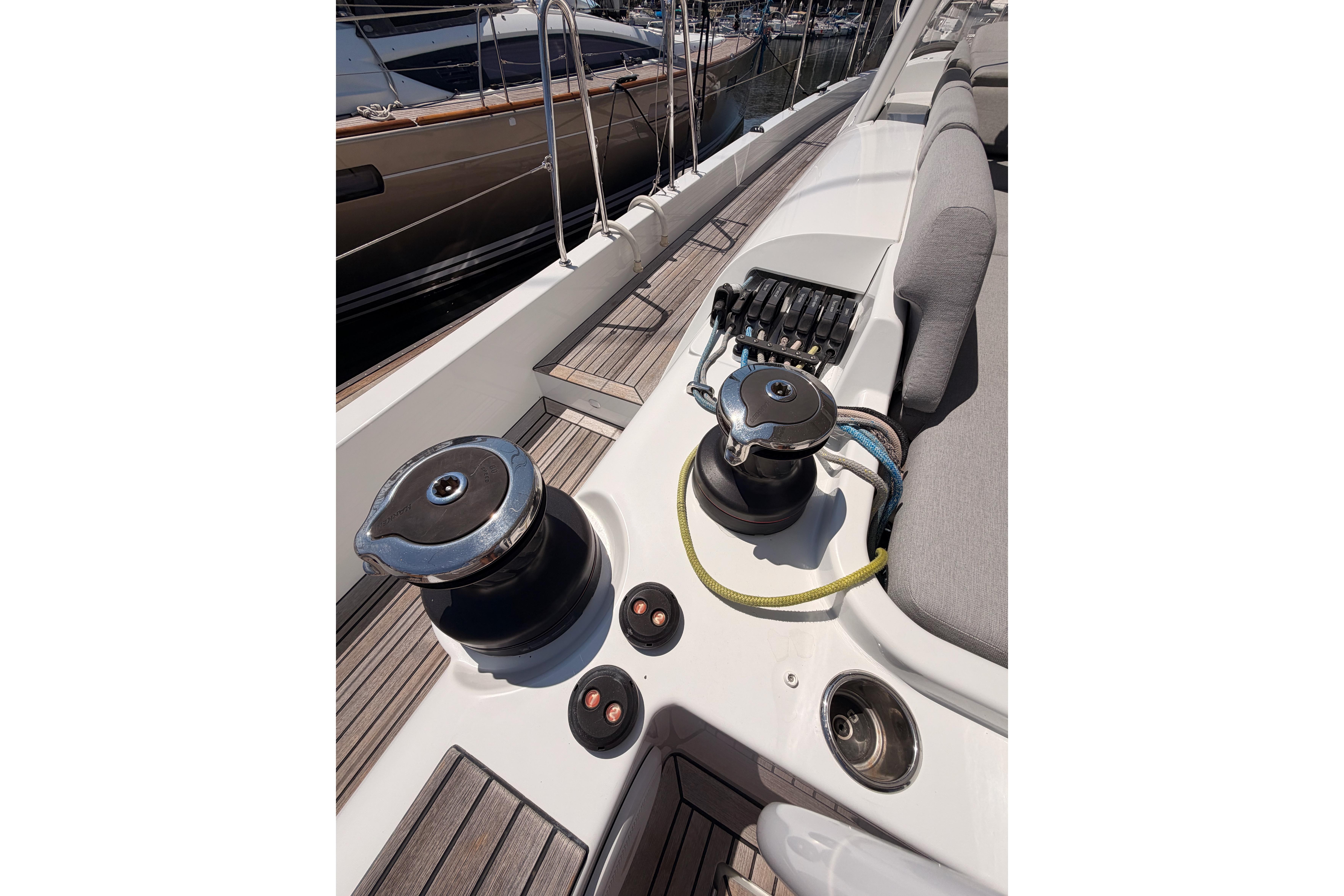 Deck view of 2022 Beneteau Oceanis Yacht 54, featuring winches and seating area.