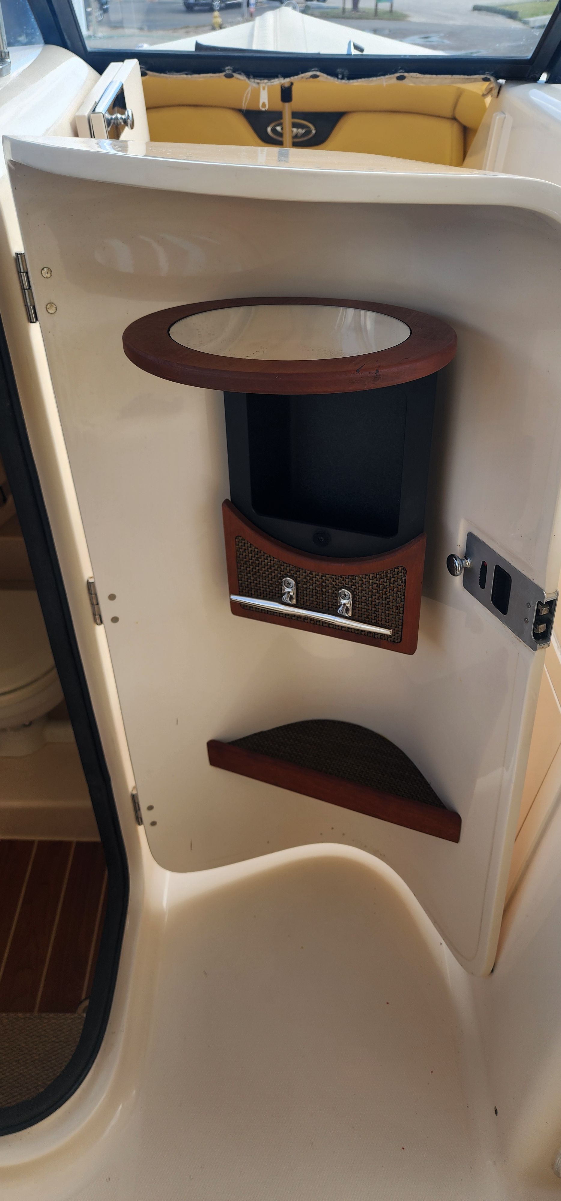 The image shows the interior of a 2015 Grady-White Freedom 275 boat. There's a small shelf and storage area.
