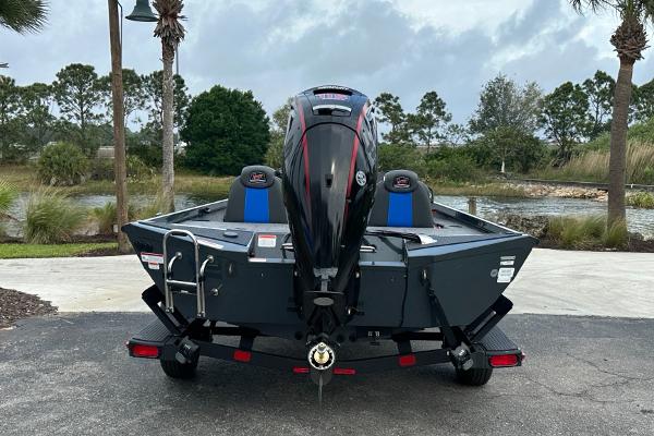 2025 Ranger RT188P boat, rear view, parked near a scenic lake with trees.