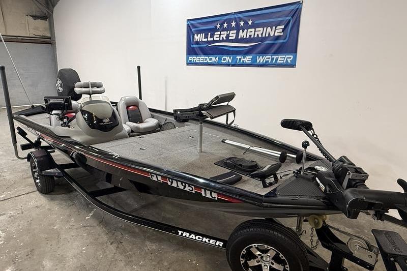 2016 Tracker Pro Team 175 TXW fishing boat in showroom, Miller's Marine banner displayed.