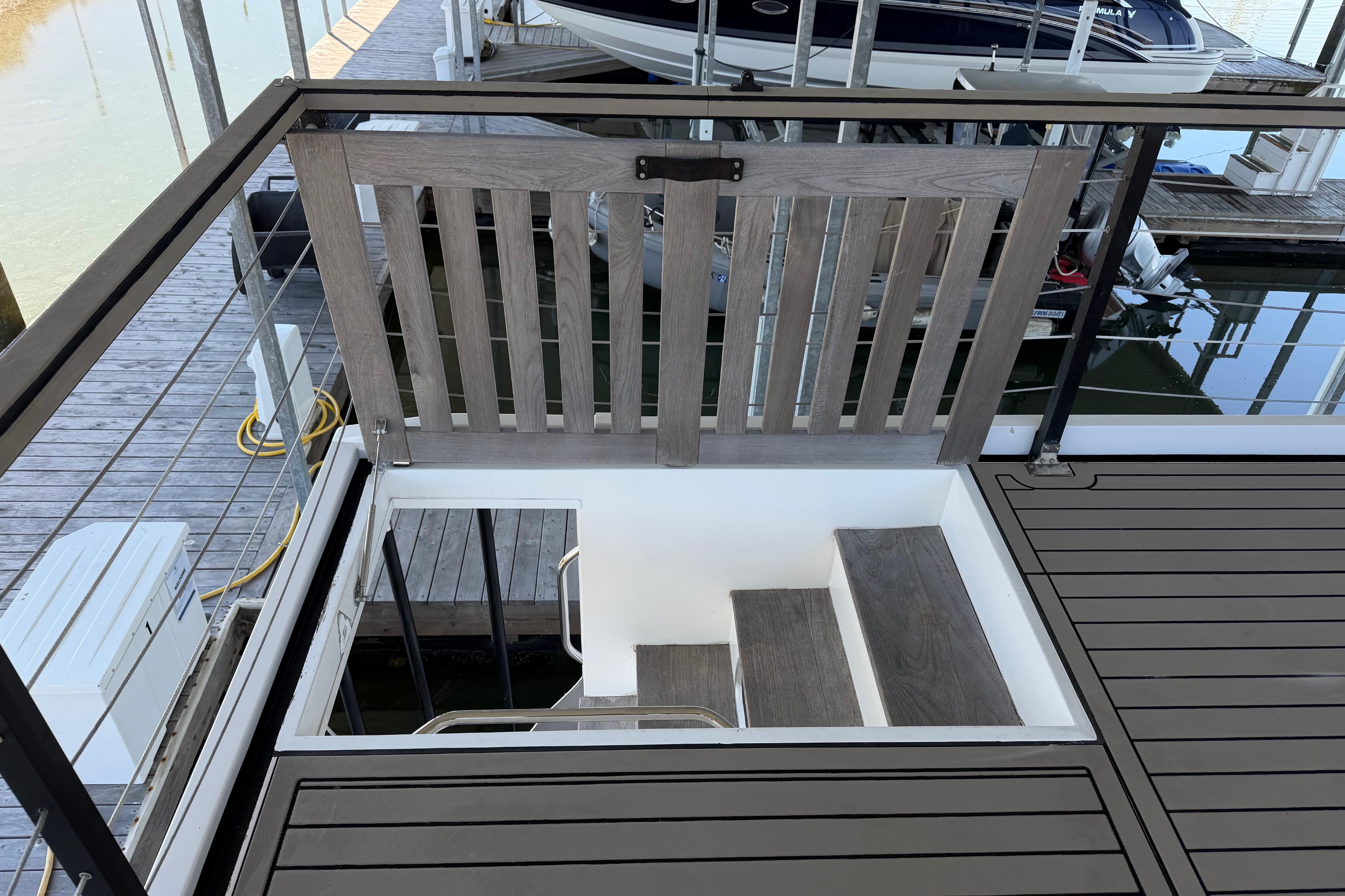 Staircase on 2022 Navisyo NV.08 yacht, featuring sleek wooden design and modern railing.