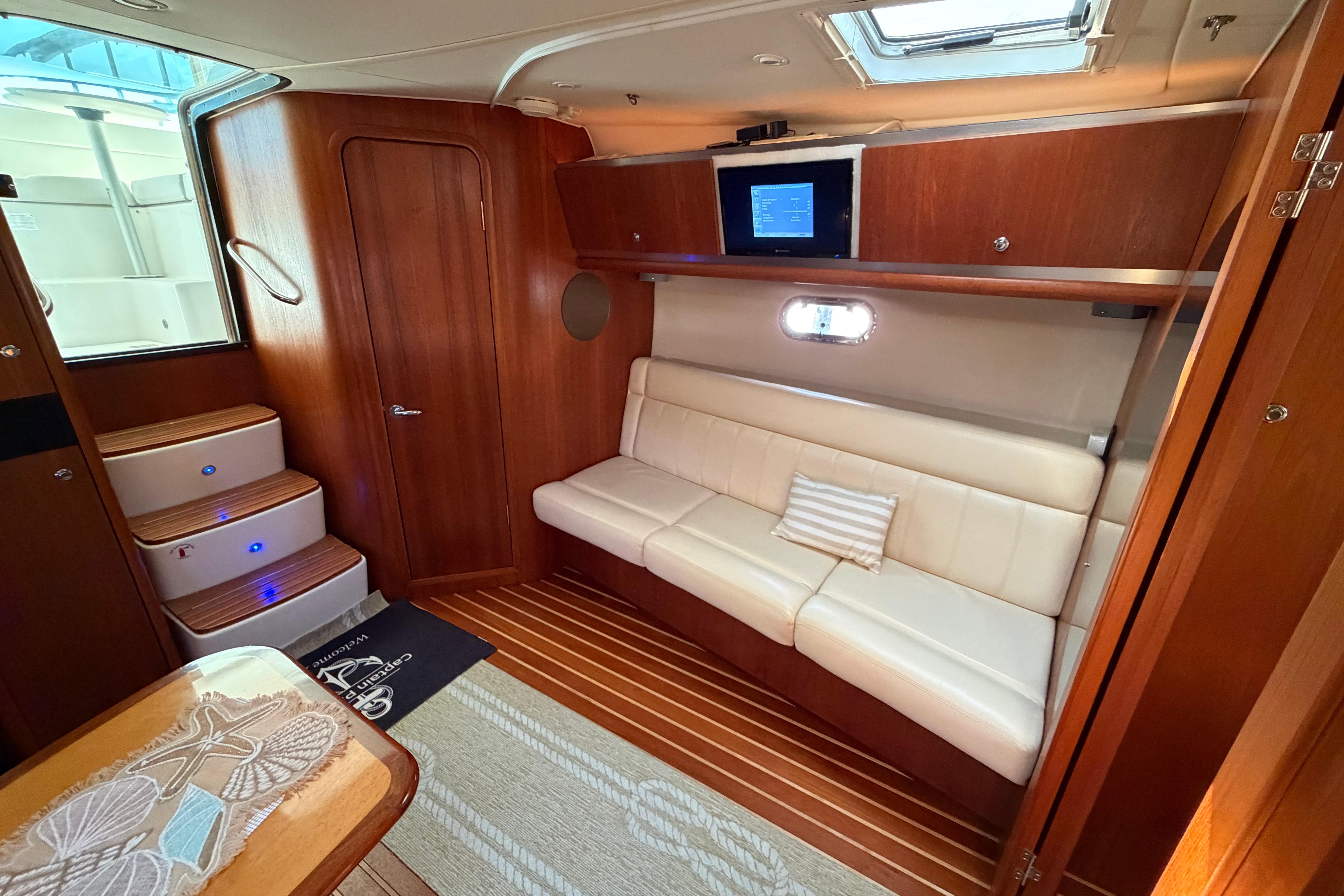 Luxurious interior of 2005 Tiara Yachts 3600 Sovran with elegant wood finish and cozy seating.