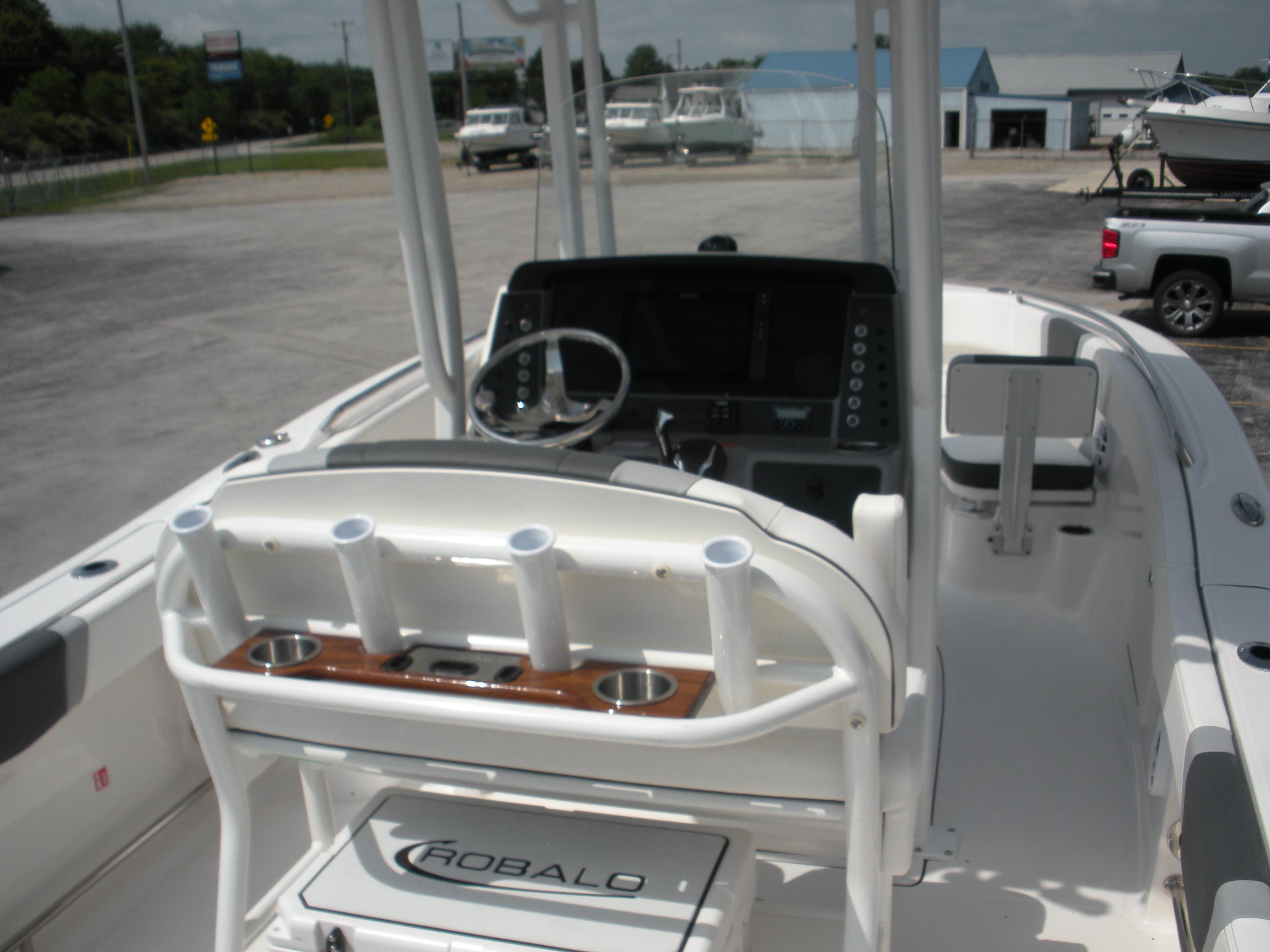 2026 Robalo R230 Center Console boat interior with steering wheel and rod holders.