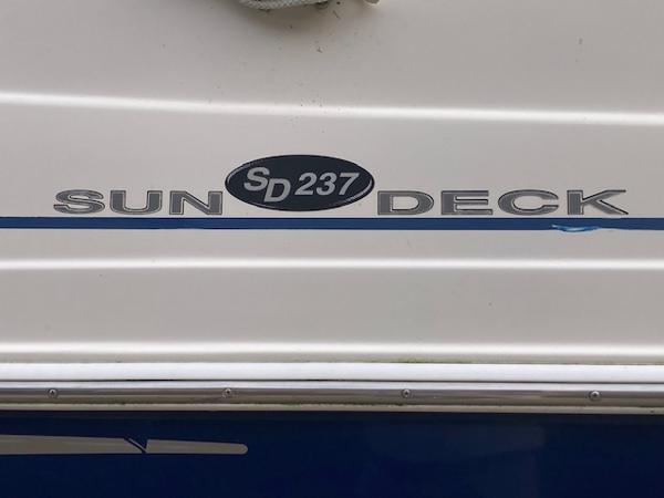 2006 Hurricane SunDeck 237 OB boat logo on white surface.