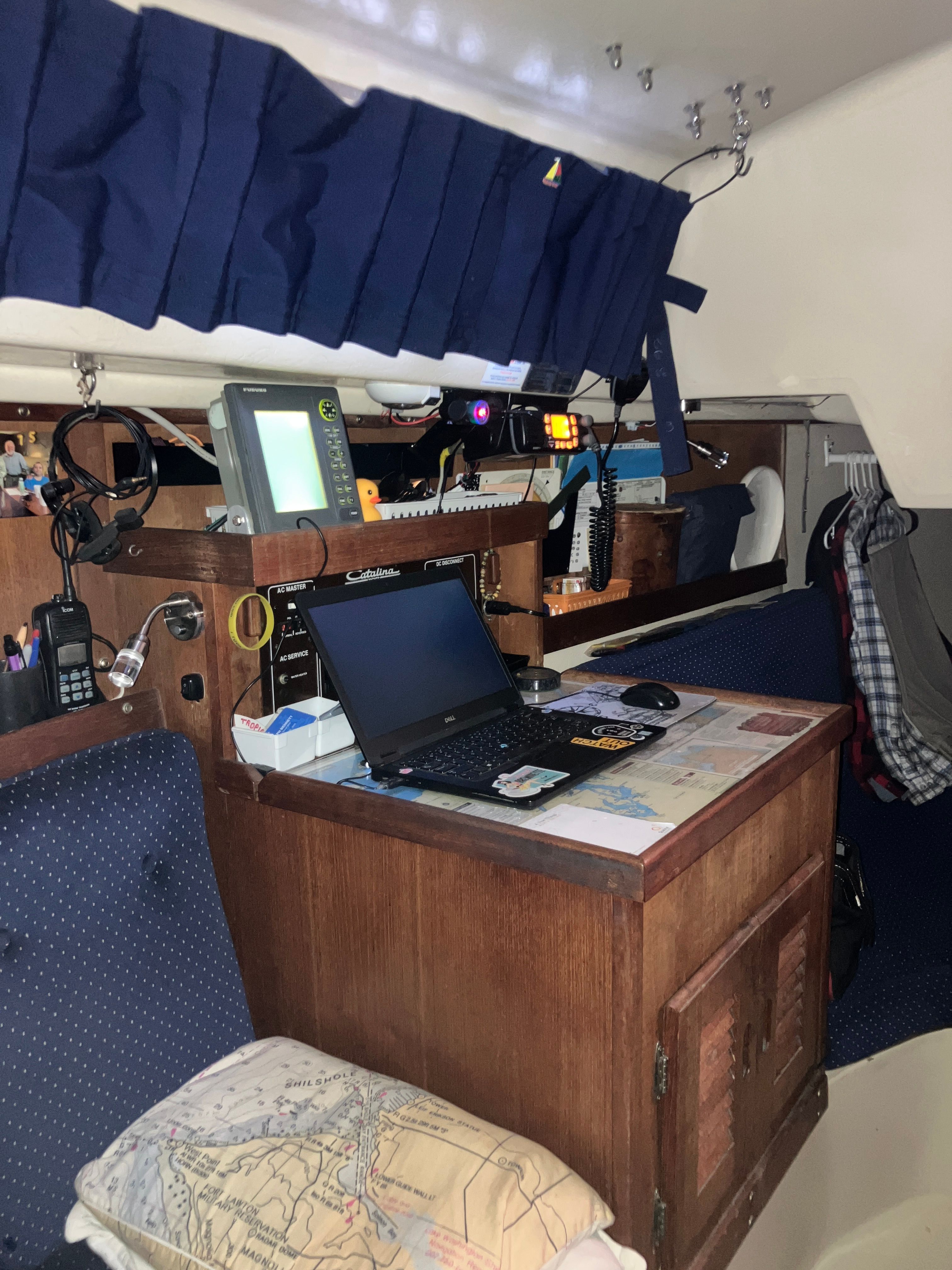 Navigation area of a 1984 Catalina 30 with laptop and charts.