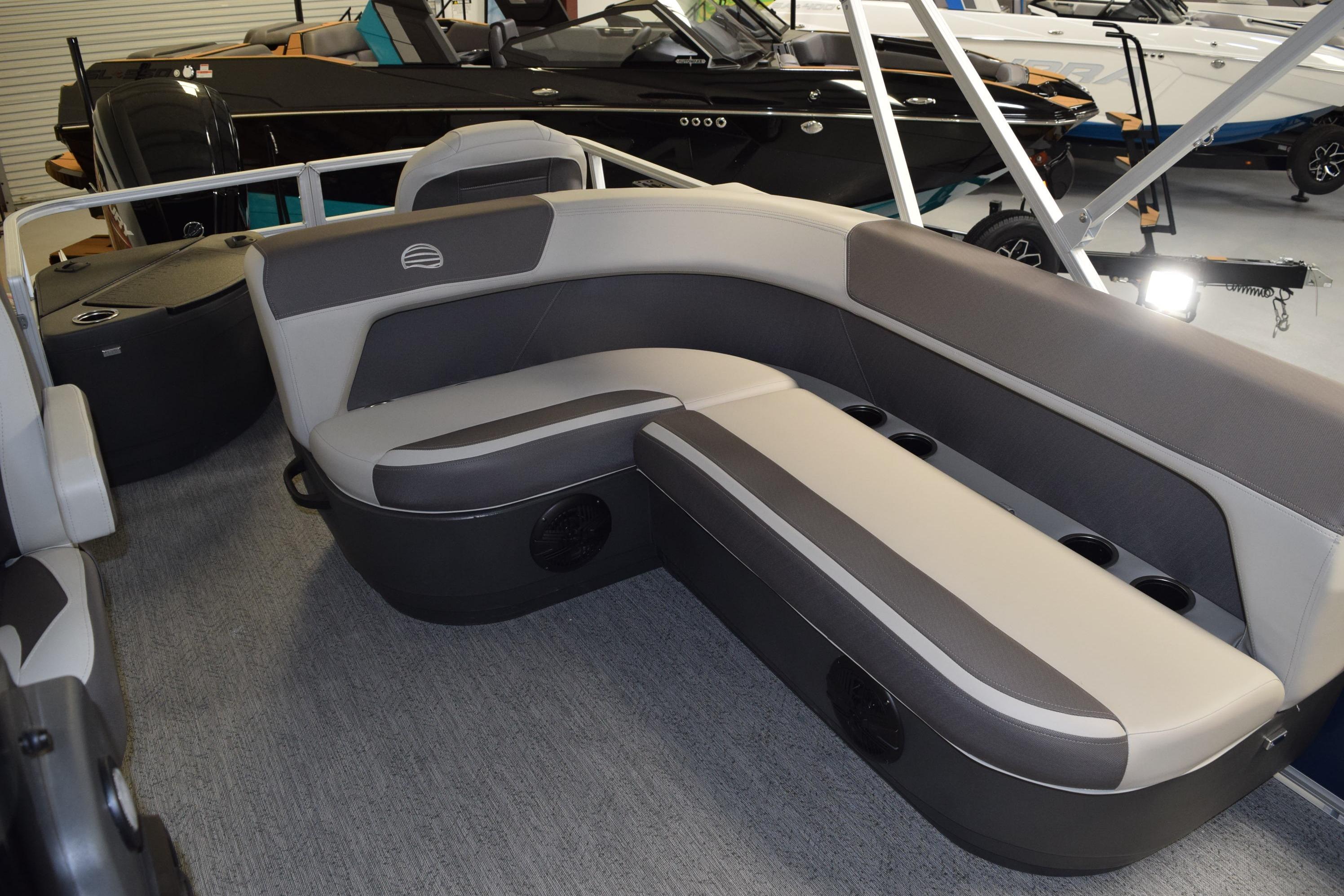 2026 Sun Tracker Bass Buggy 18 DLX pontoon boat interior with gray seating and cup holders.