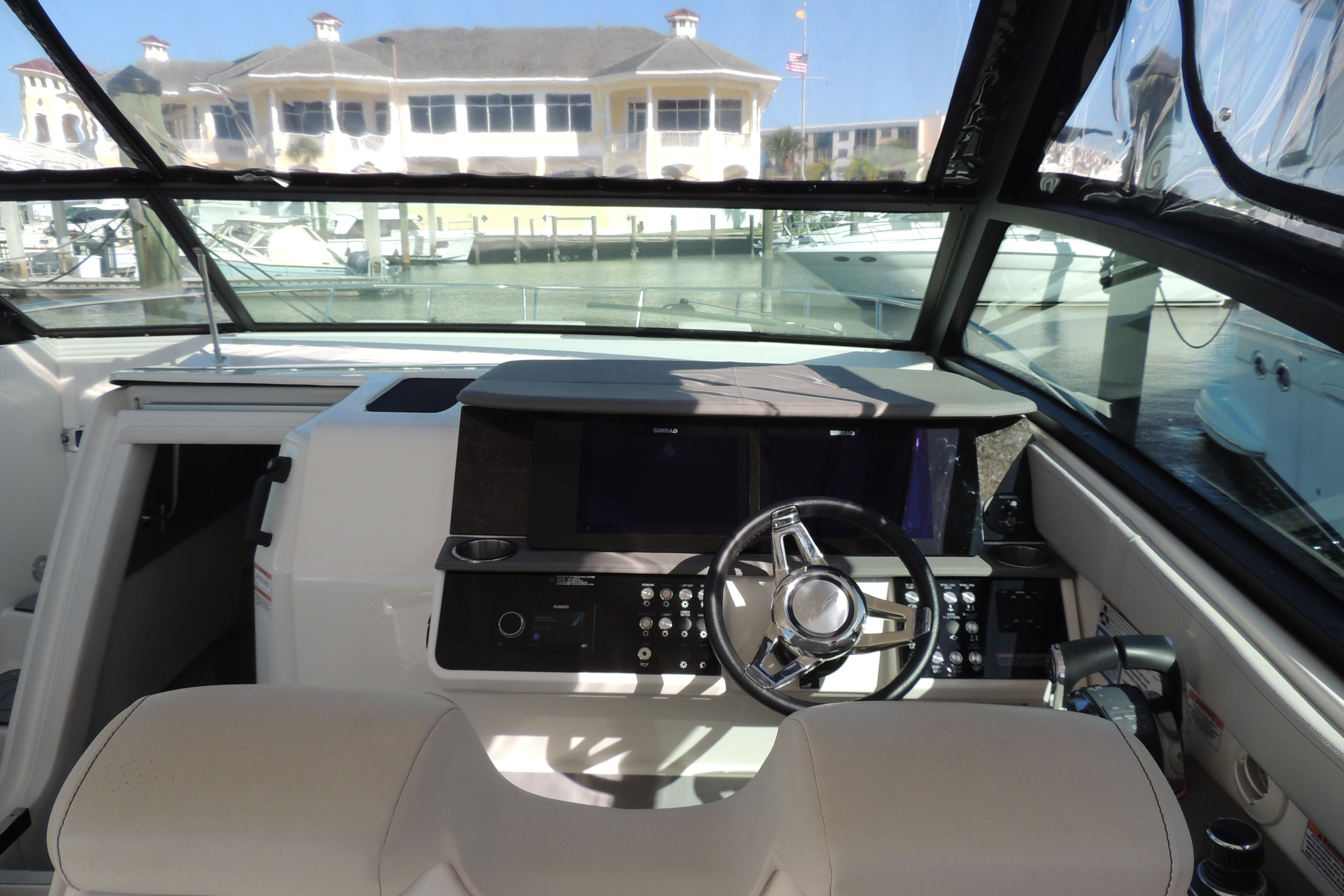 2020 Sea Ray Sundancer 320 Outboard helm with modern controls and waterfront view.