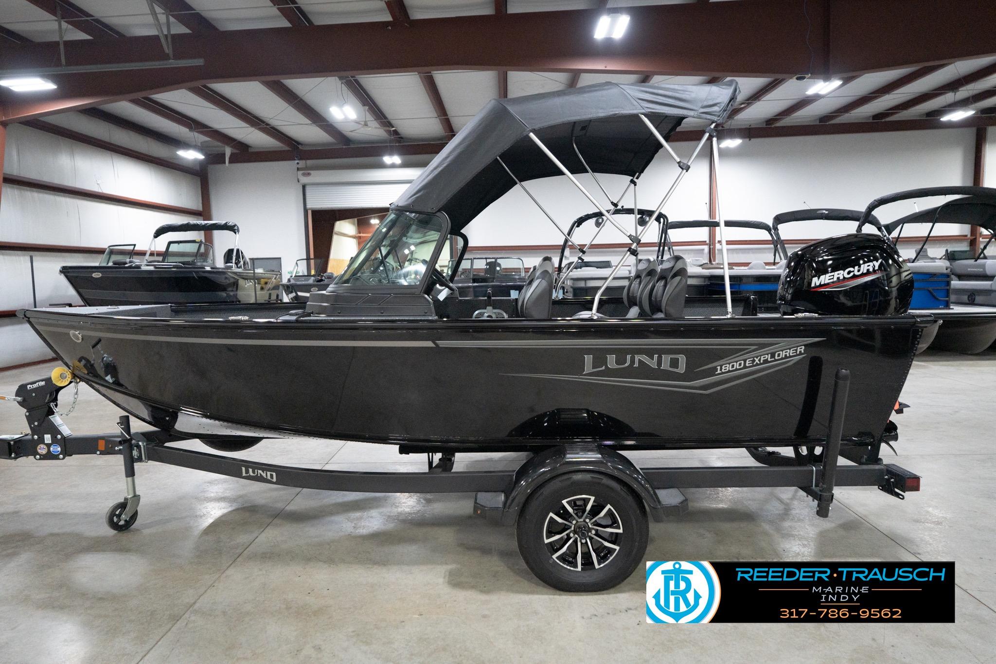 2026 Lund 1800 Explorer Sport boat in showroom with Mercury engine.