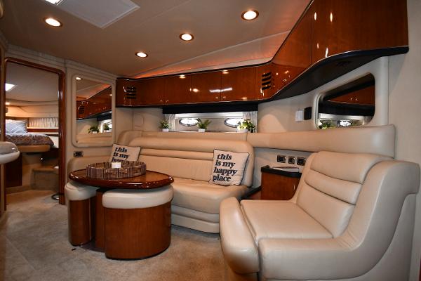 Luxurious interior of 2003 Sea Ray 460 Sundancer yacht with plush seating and elegant wood finishes.