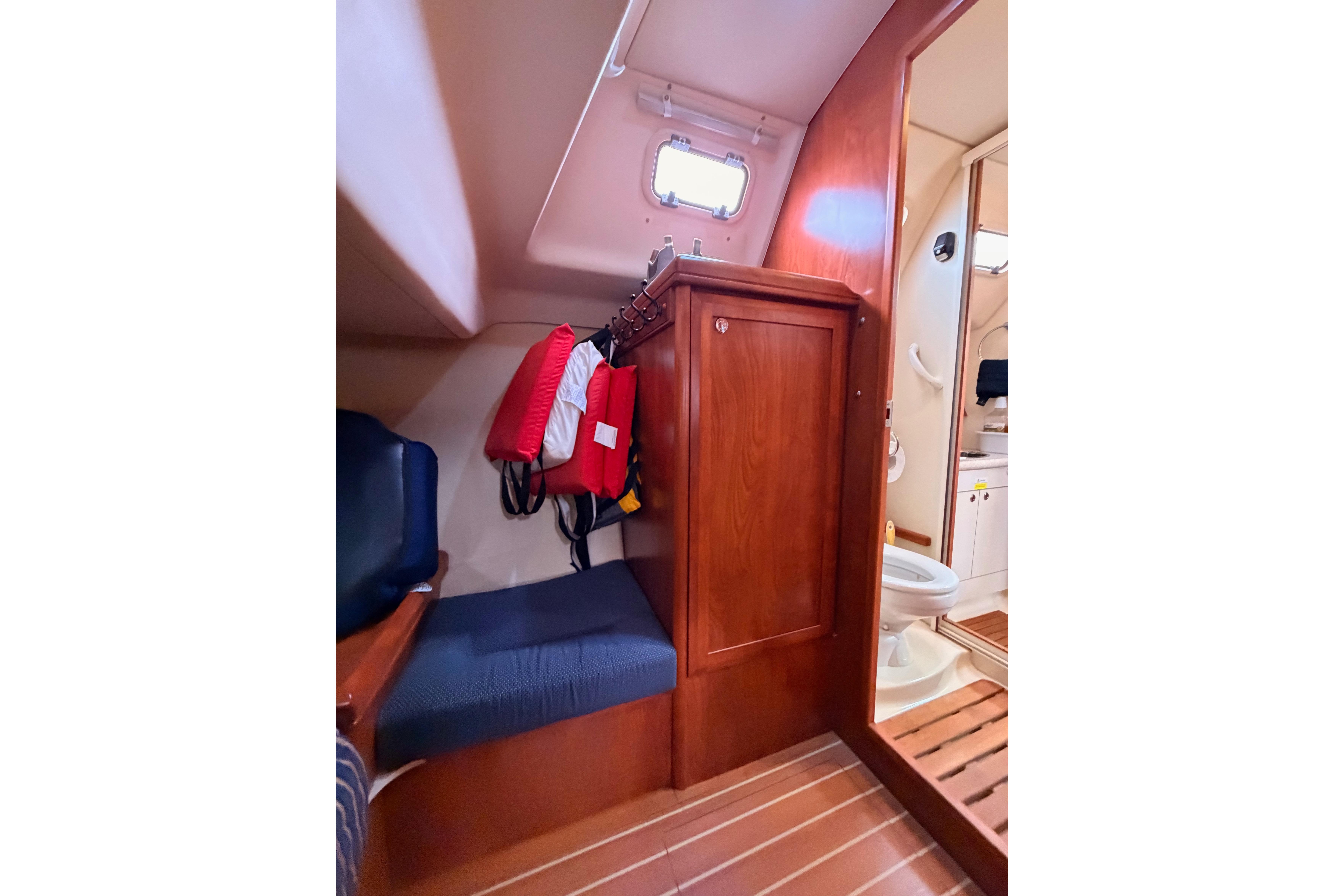 Interior of 2009 Hunter 38 sailboat with seating, storage, and bathroom area.