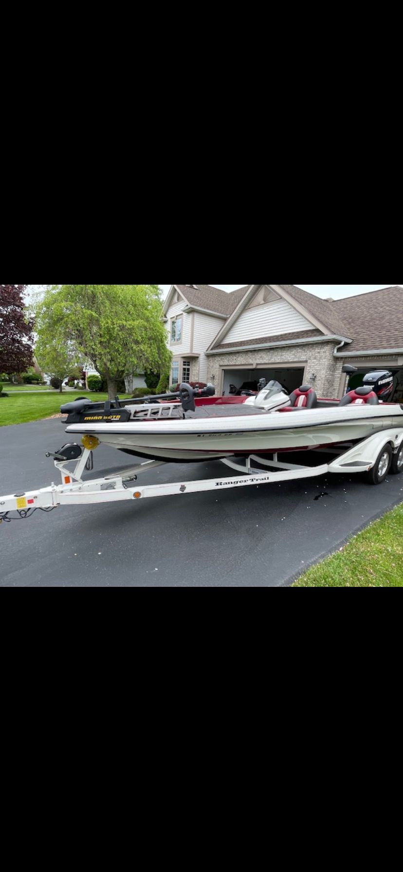 A 2009 Ranger Z520 Comanche on a trailer in front of a house.