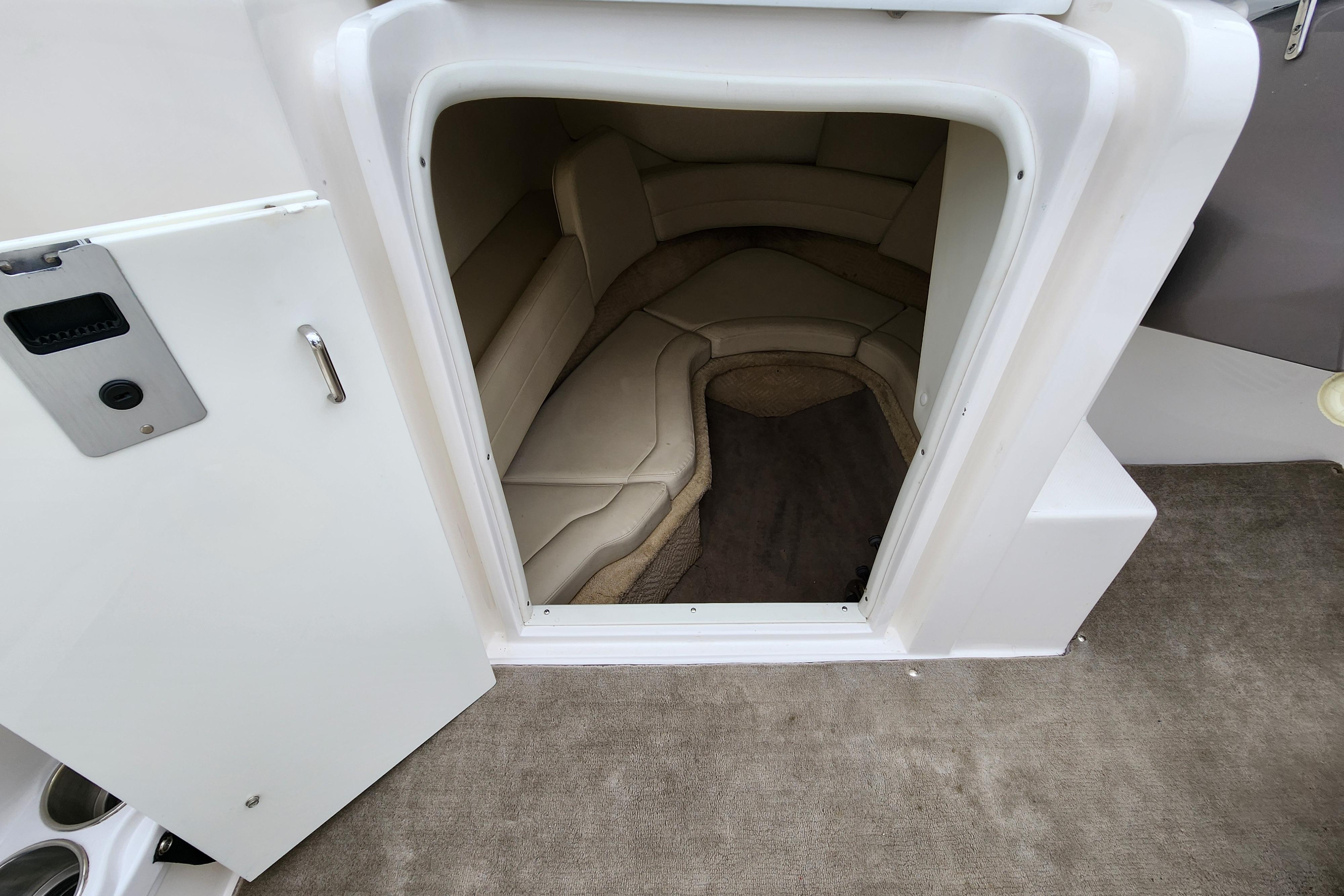 2009 Rinker 210 Captiva MTX Cuddy cabin interior with beige seating and carpet.