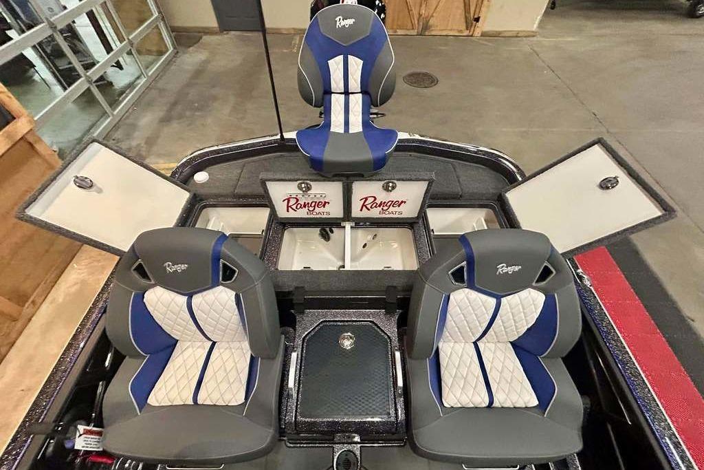 2026 Ranger Z521R Cup-Equipped boat interior with blue and white seats, storage compartments open.