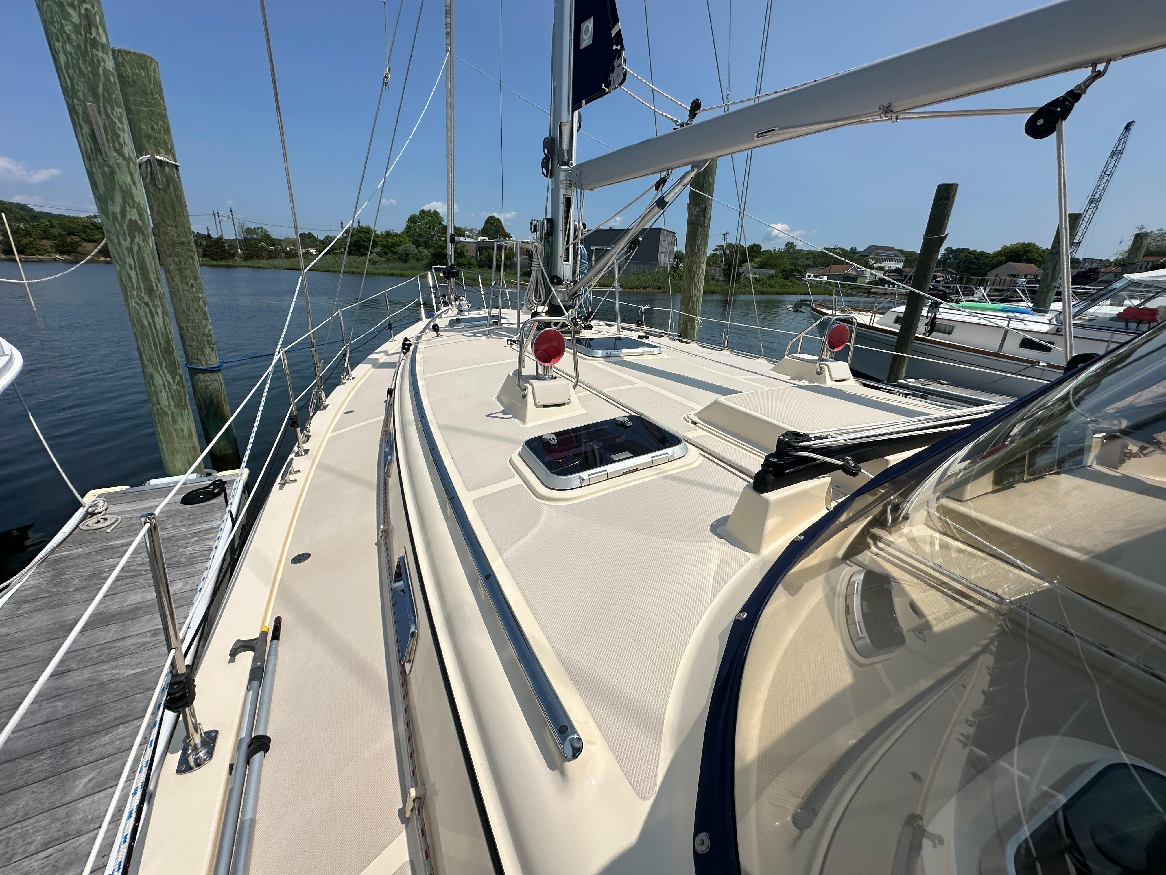 2021 Island Packet 439 sailboat docked, showcasing deck and rigging under clear skies.