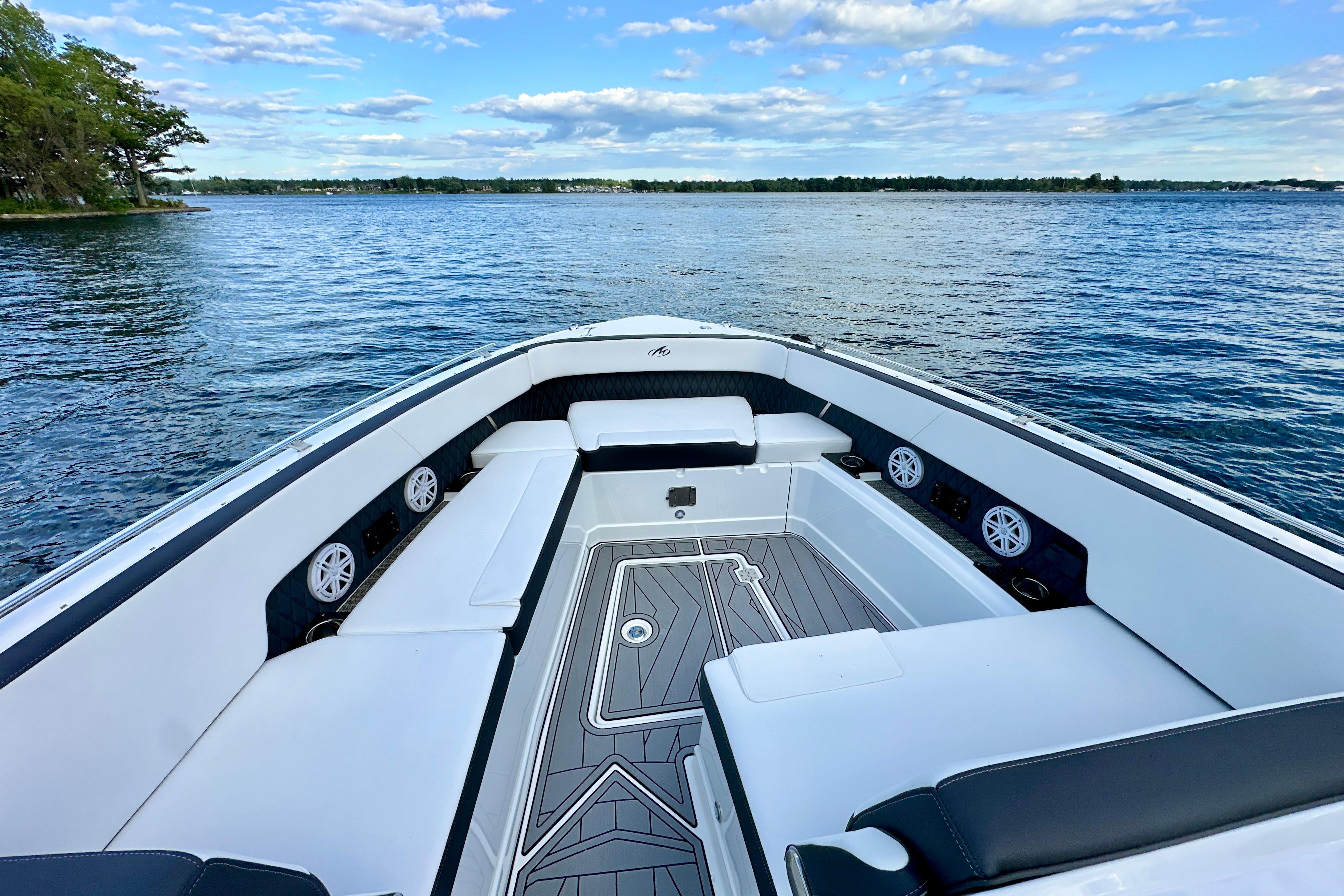 2022 Monterey 378SS Super Sport boat interior with spacious seating on a serene lake.