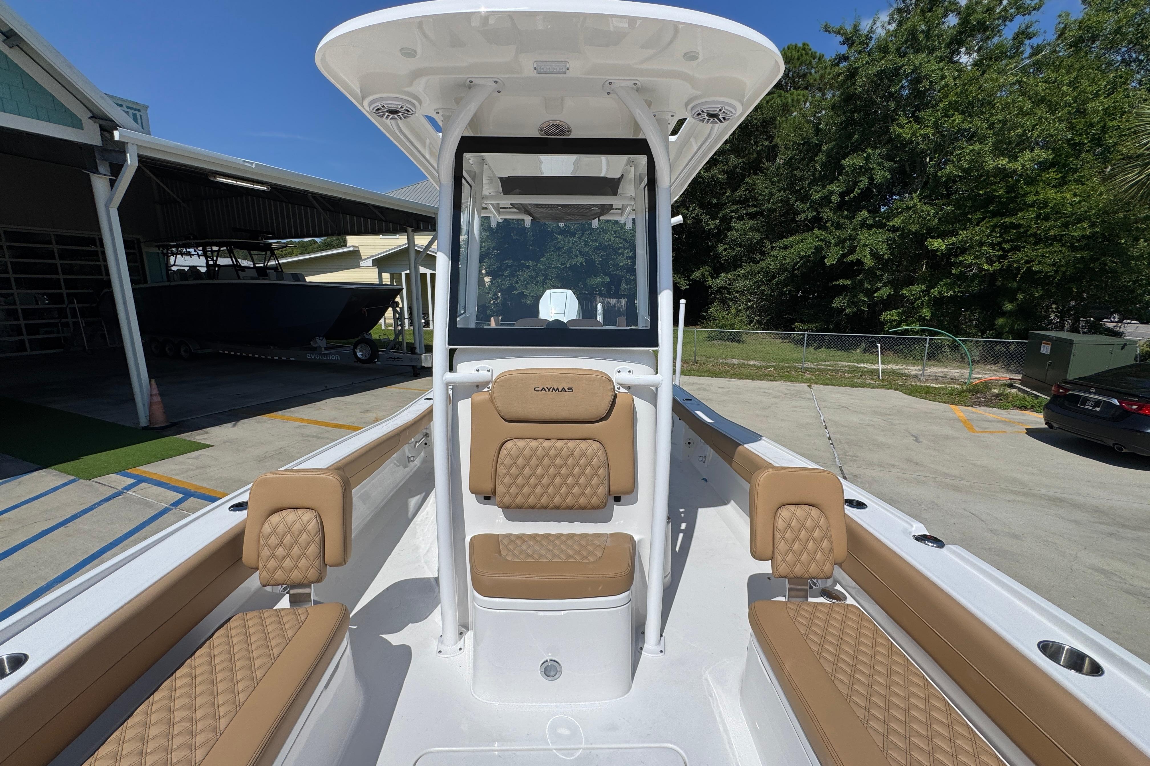2027 Caymas 26 HB boat interior with tan seating and center console.