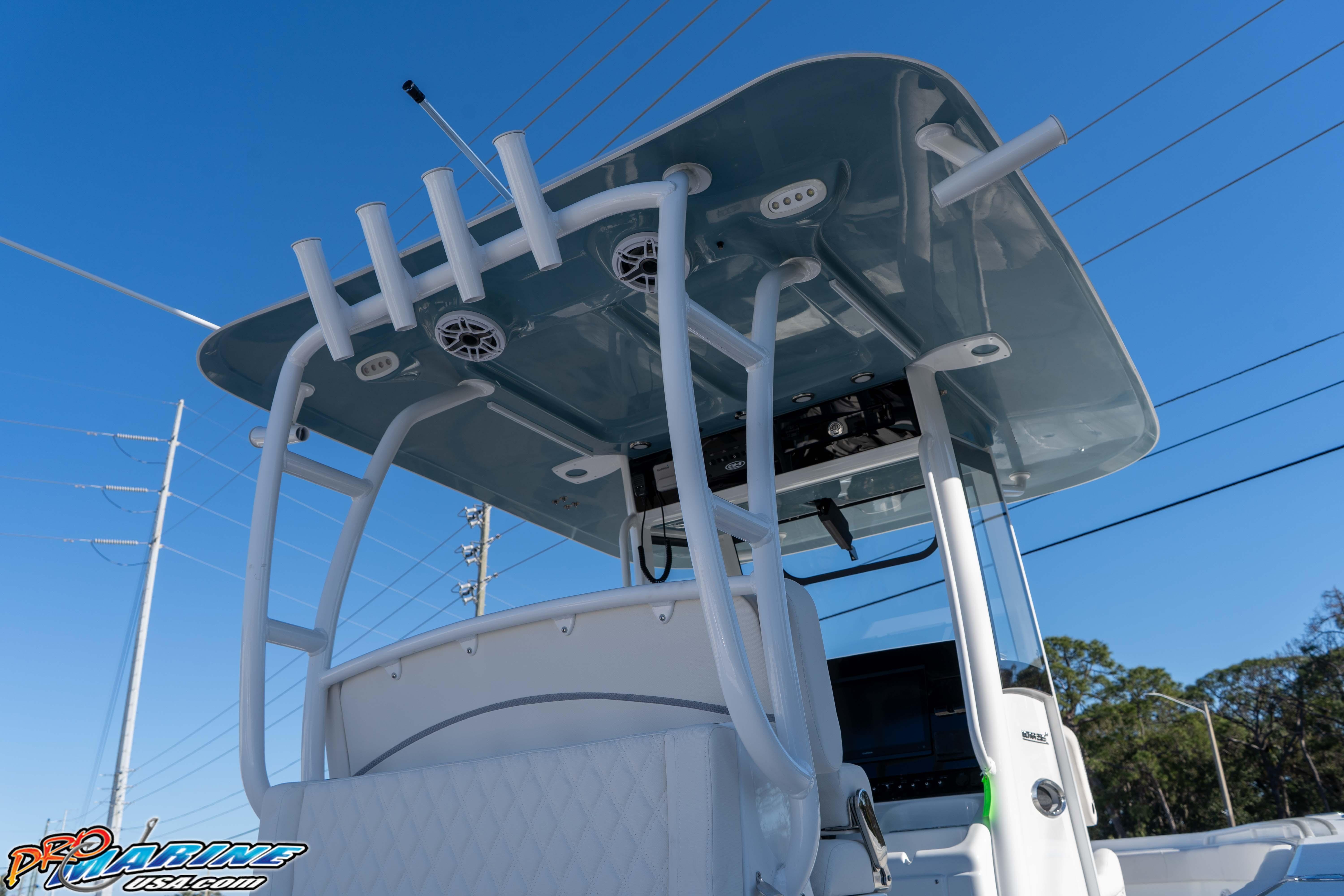 2026 Sea Hunt Ultra 285 Coffin Box boat with T-top and rod holders against blue sky.