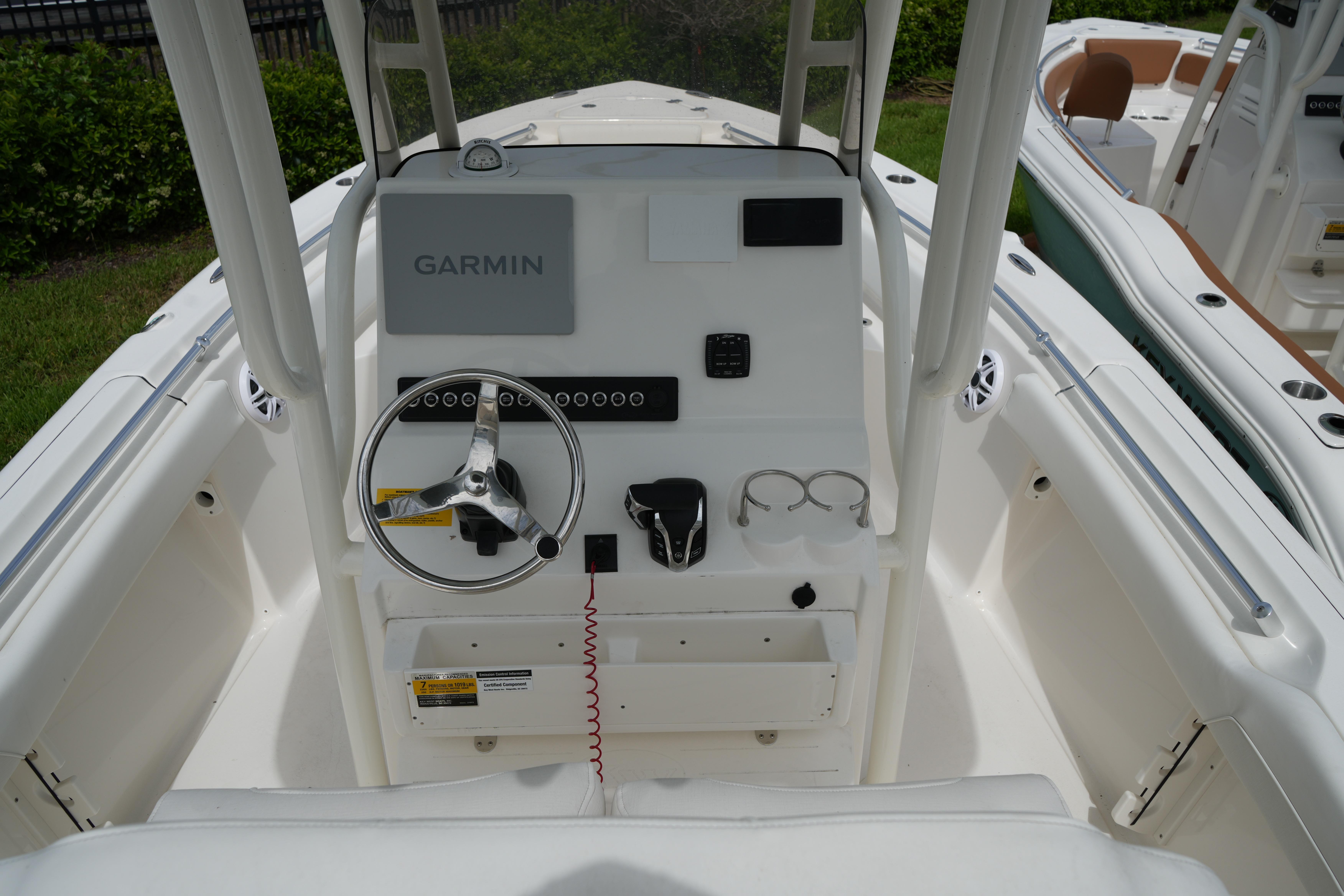 2026 Key West 219 FS boat dashboard with Garmin navigation system and steering wheel.