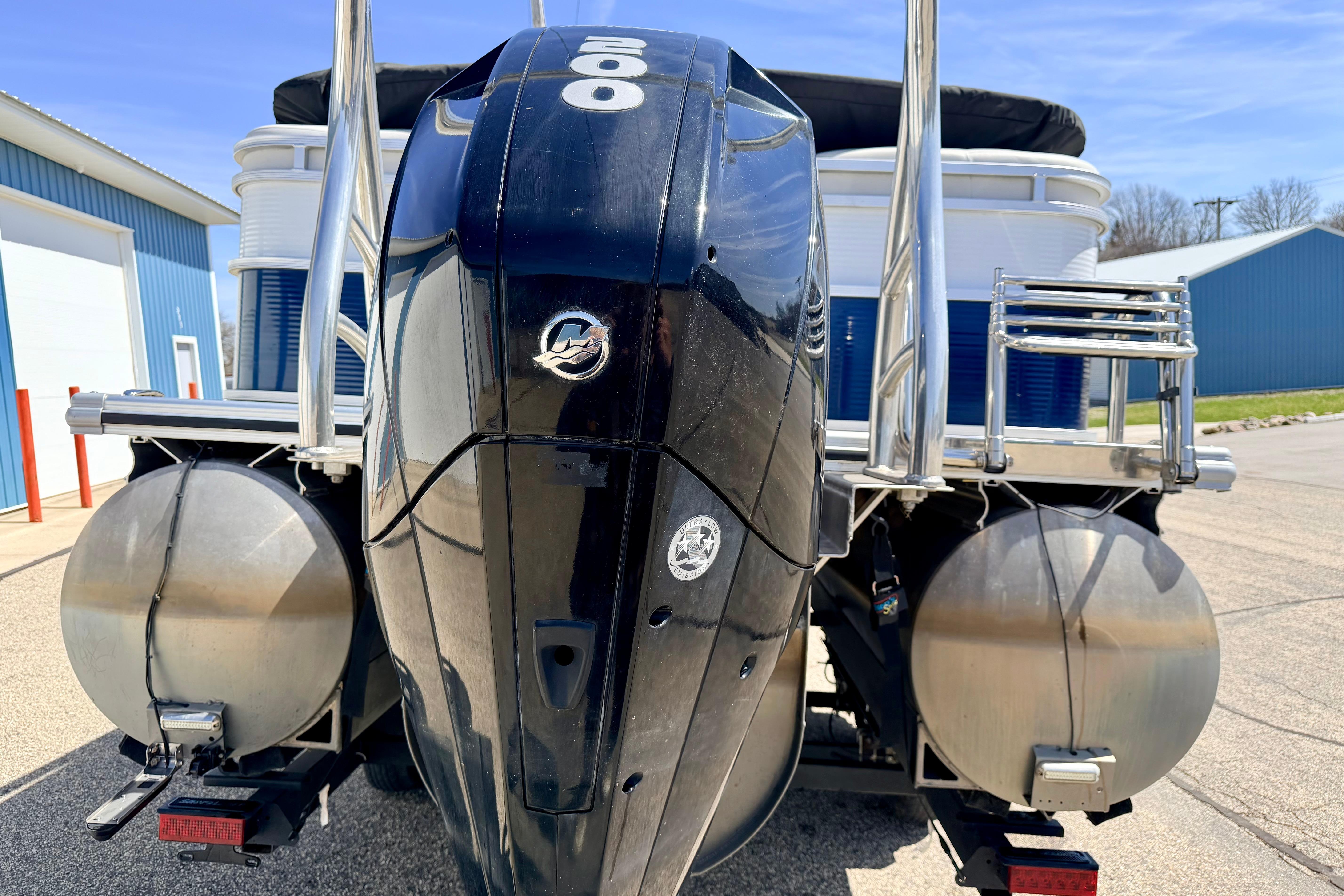 2019 Crestliner 240 Rally DX CW boat with powerful outboard motor, docked outdoors.