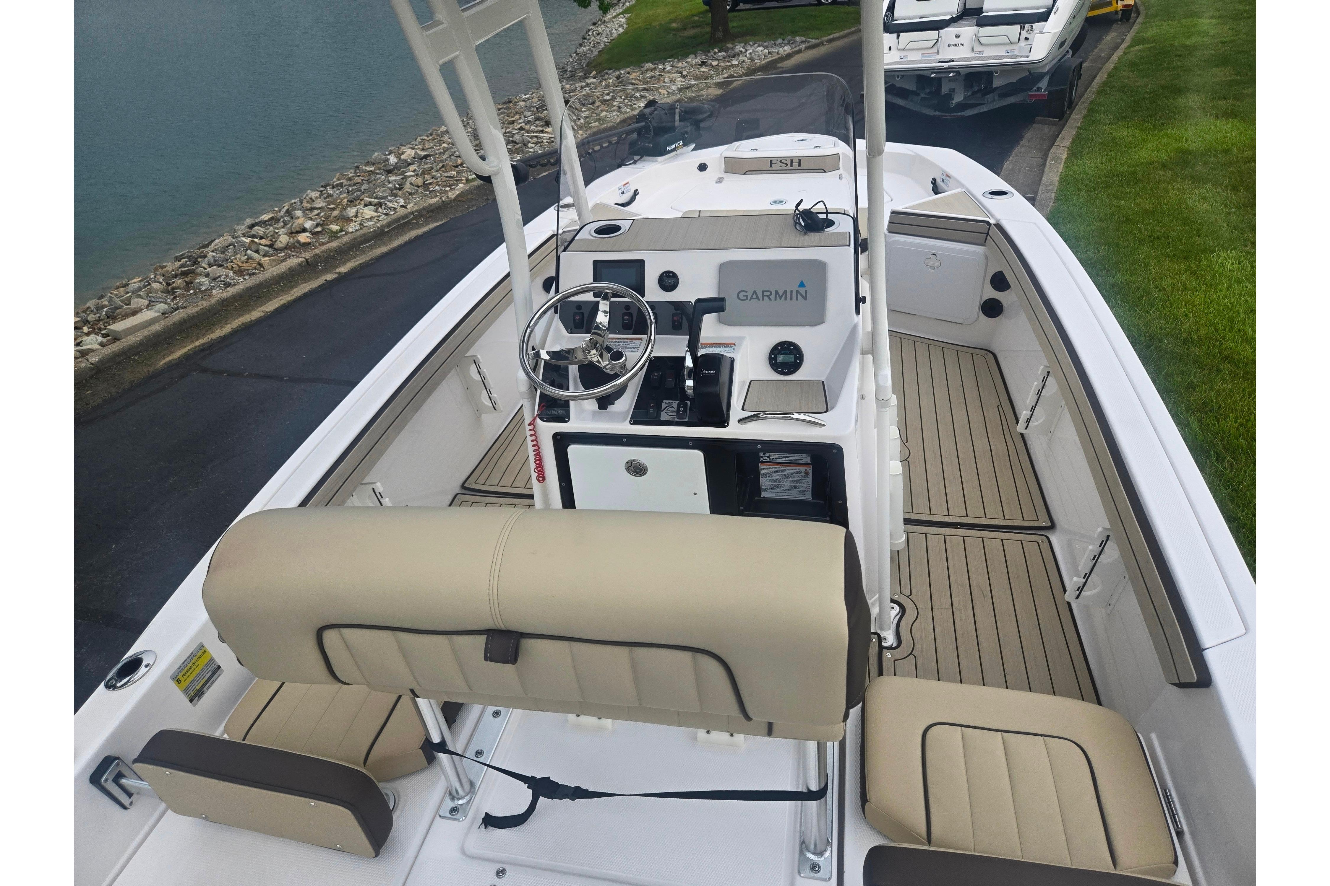 2022 Yamaha Boats 195 FSH Sport interior with Garmin navigation, beige seating, and sleek design.