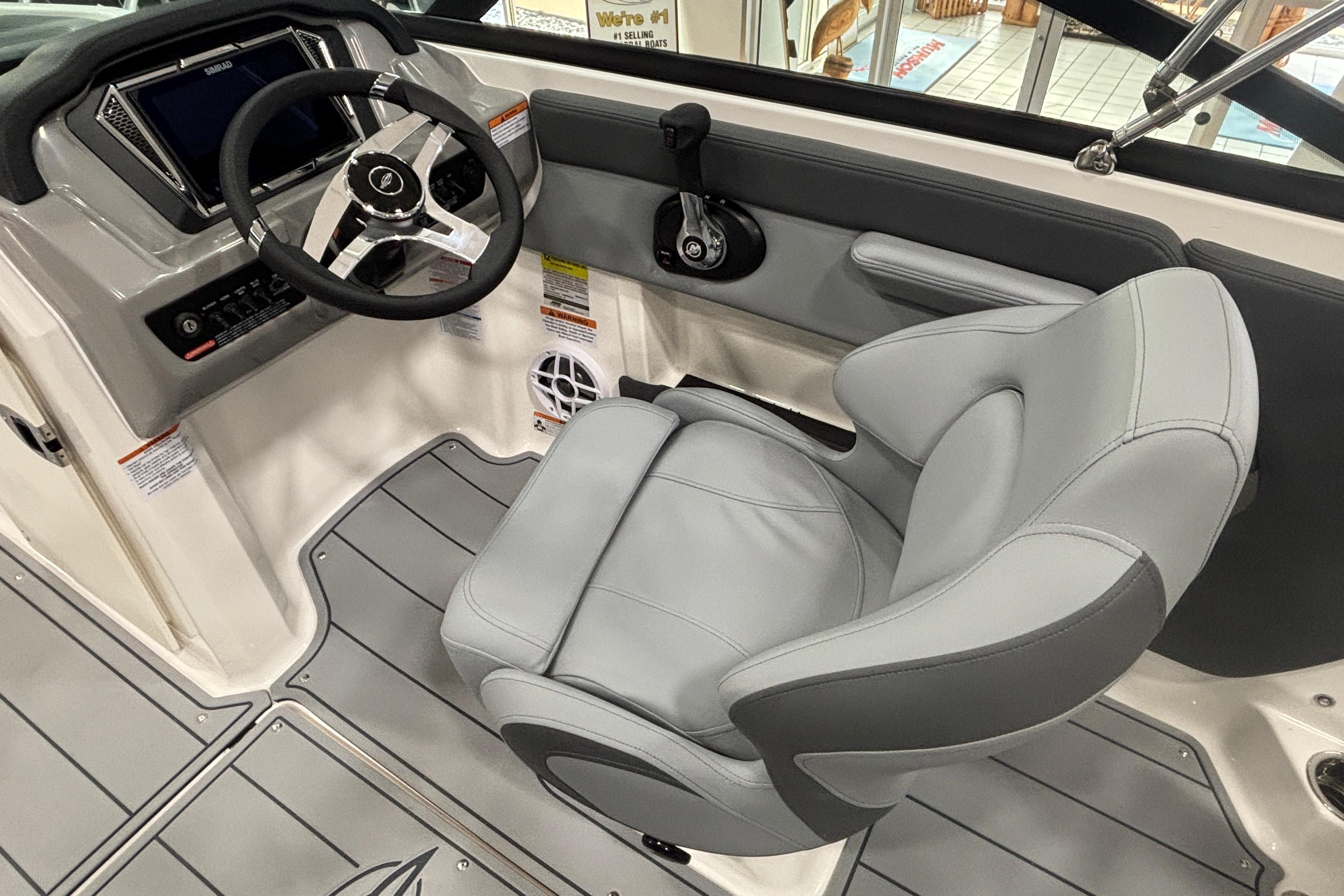 2026 Chaparral 21 SSi interior with gray seat and steering wheel.