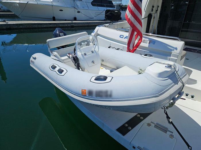 2004 Carver 560 Voyager PH with inflatable dinghy docked at marina.