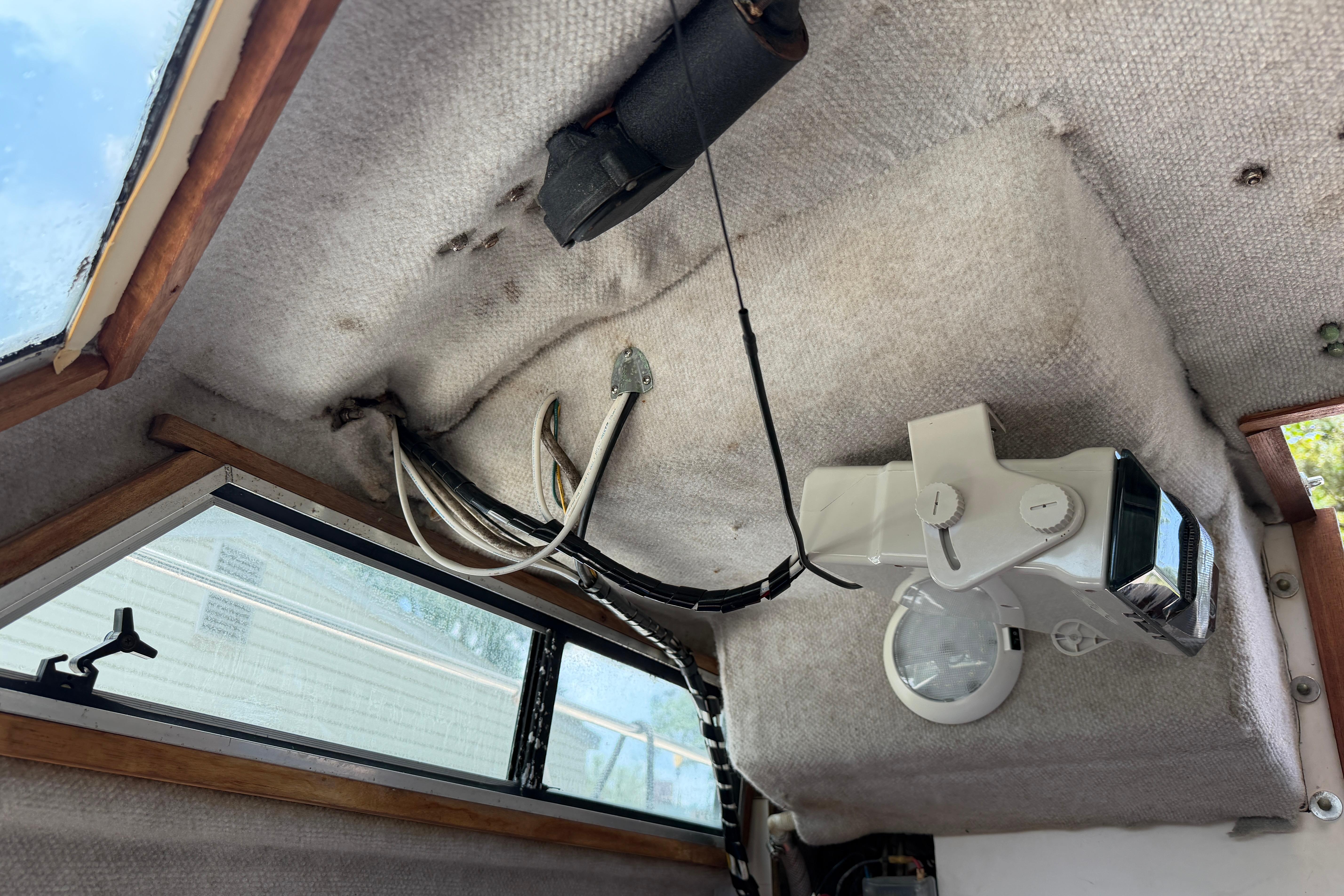 Interior view of a 1987 Grady-White Seafarer 226 boat with visible wiring and equipment.