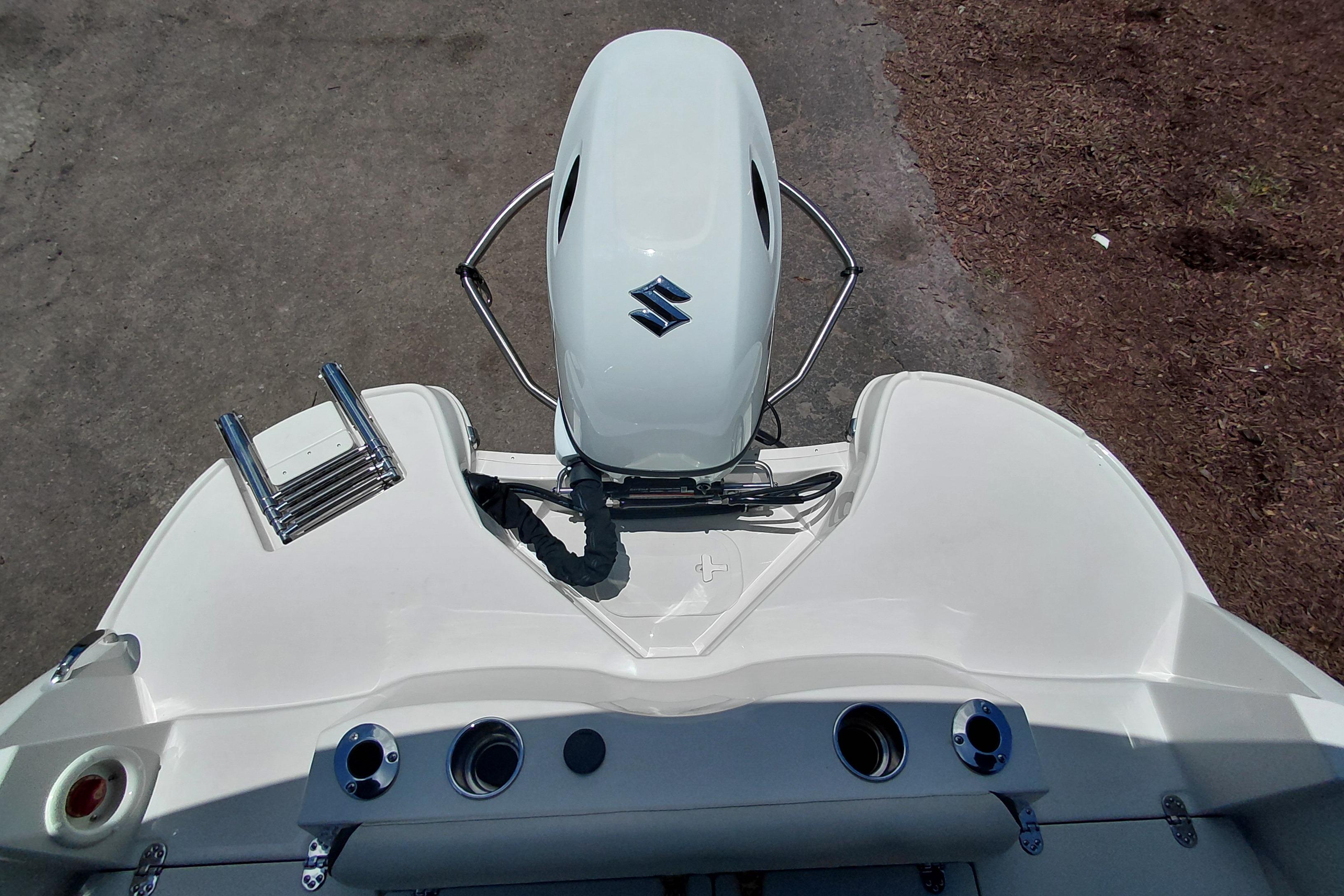 2023 Stingray 206 CC boat with Suzuki outboard motor, rear view.