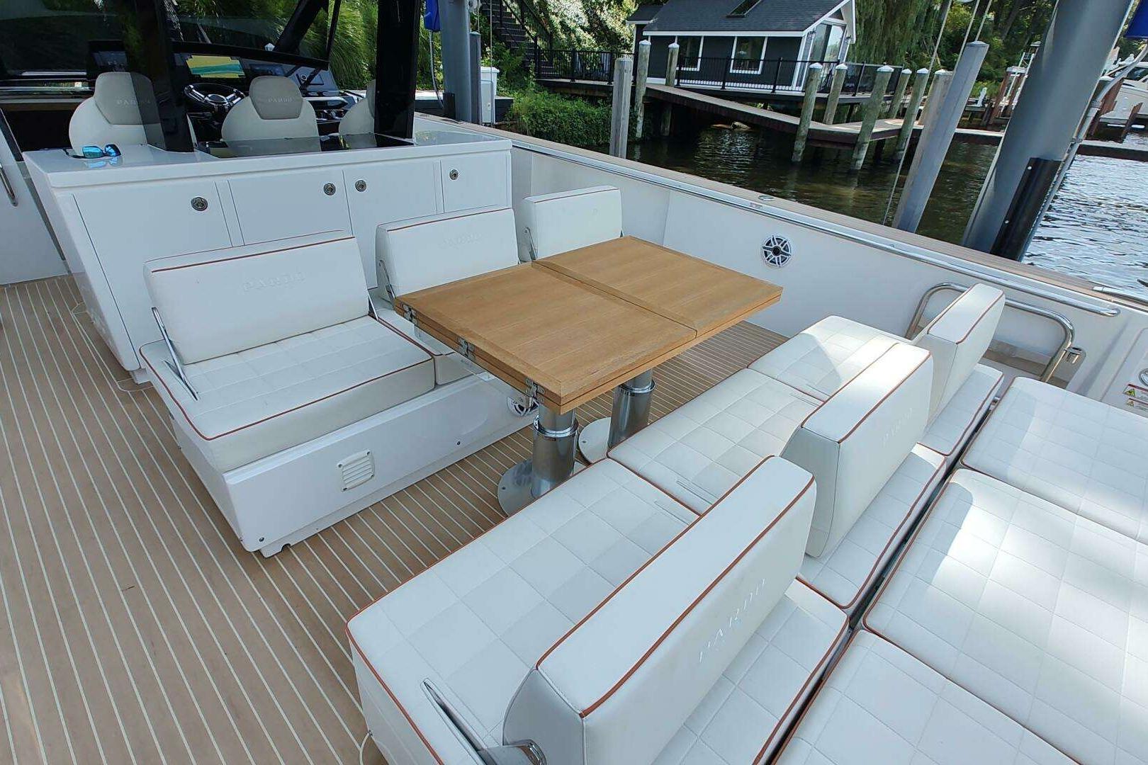 Luxurious seating area on 2023 Pardo Yachts P43 with elegant wooden table.