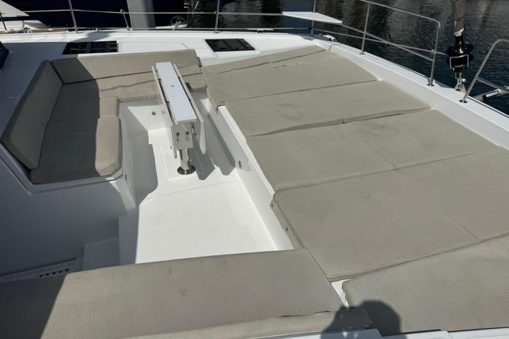 Spacious deck seating on 2023 Bali 4.6 yacht, featuring cushioned lounge area.