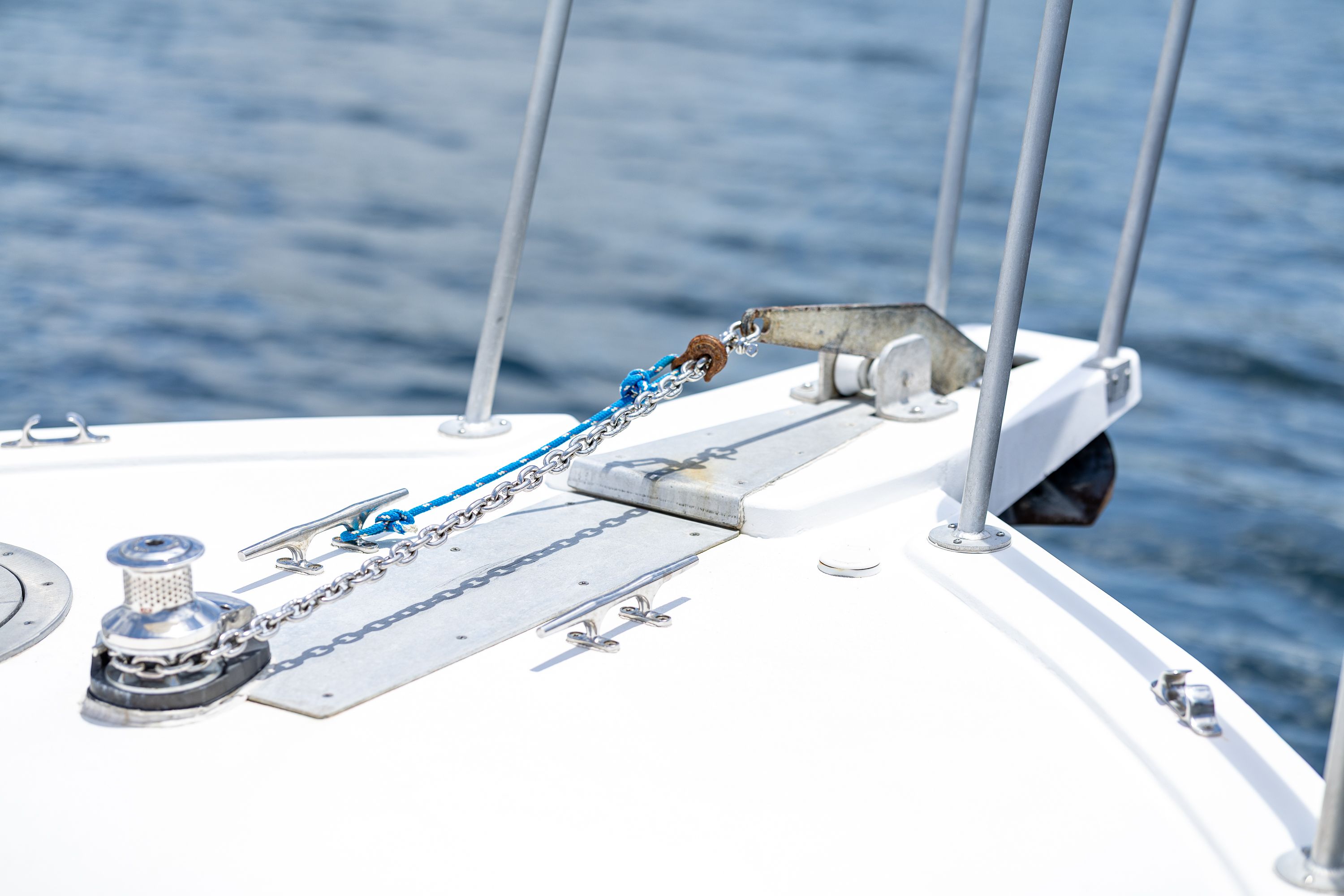 The image shows the bow of a boat with anchor chain and windlass.