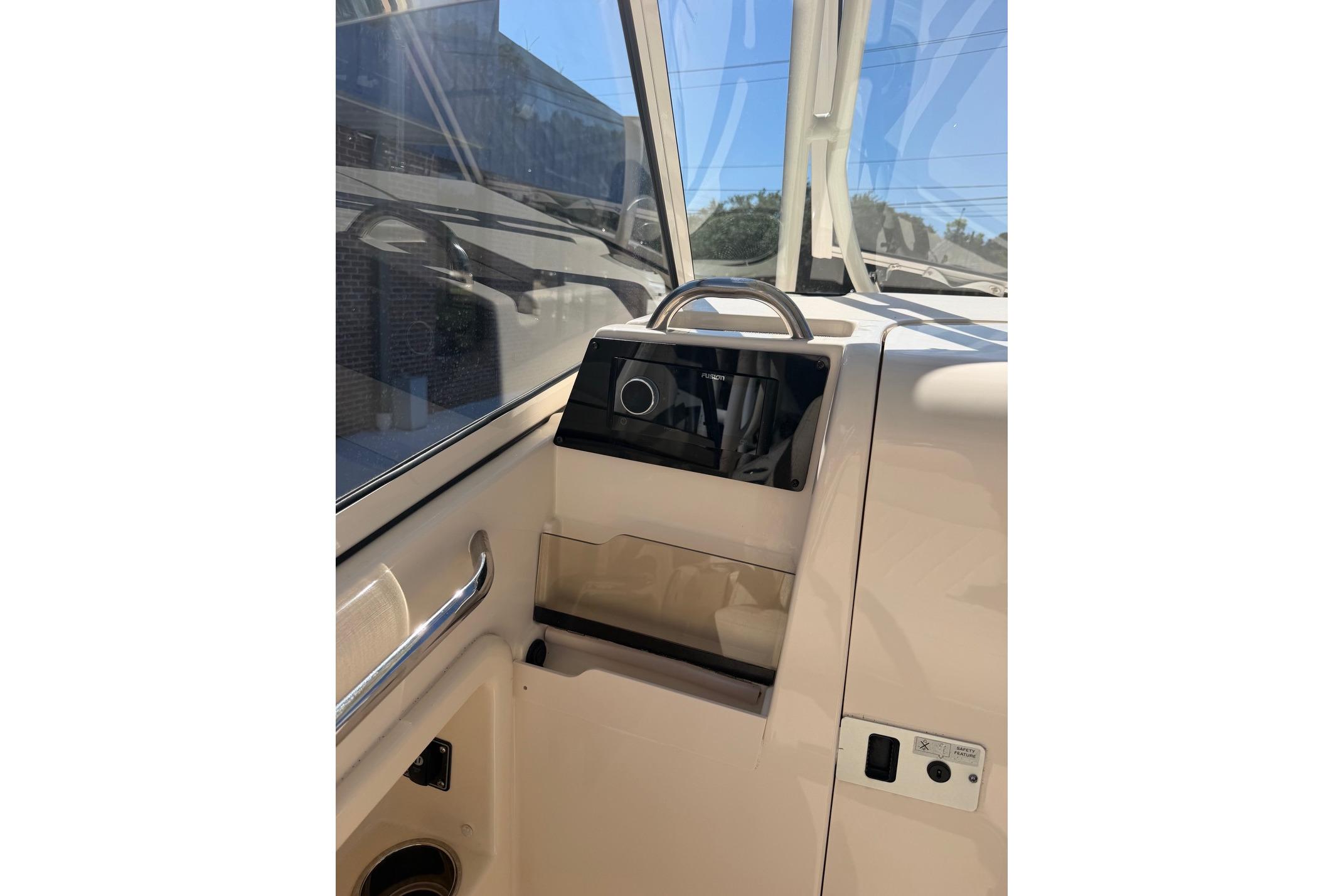2022 Grady-White Freedom 275 boat interior with control panel and window view.