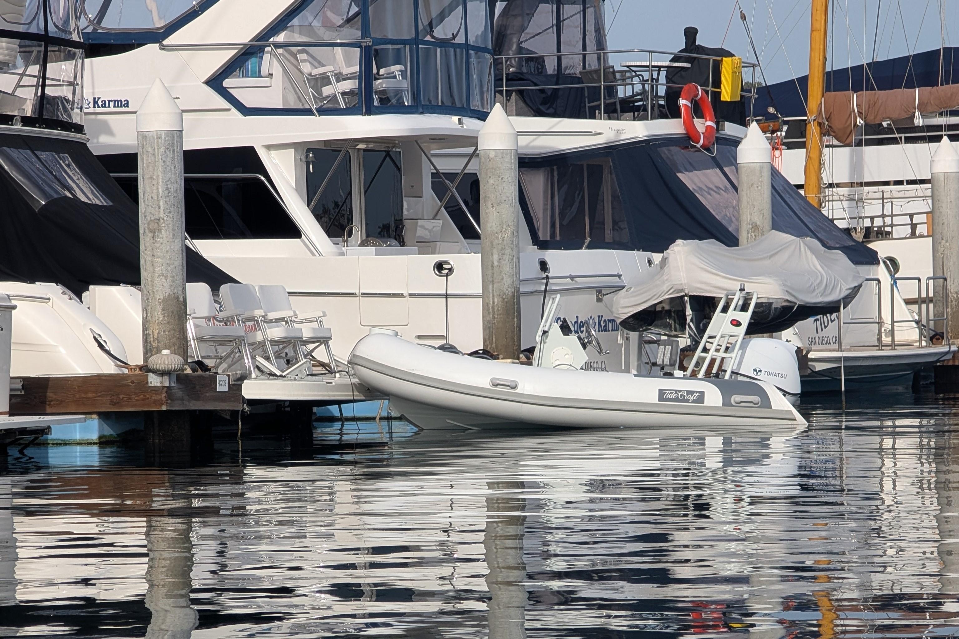 Docked Tide Craft Nantucket 12 boat, 2025 model, at a marina with yachts.