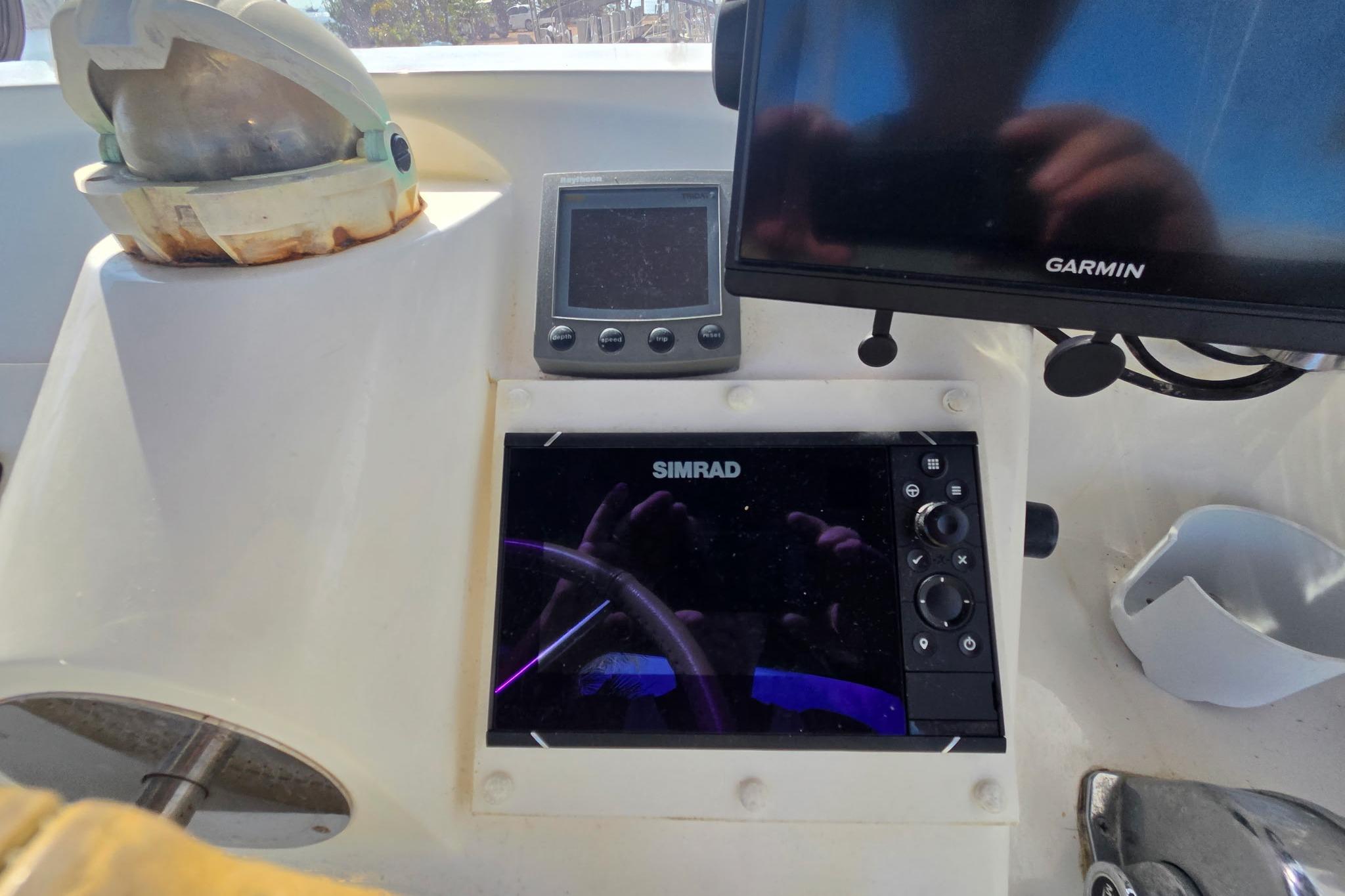 Control panel of a 2000 Fountaine Pajot Maryland 37 with Simrad and Garmin displays.