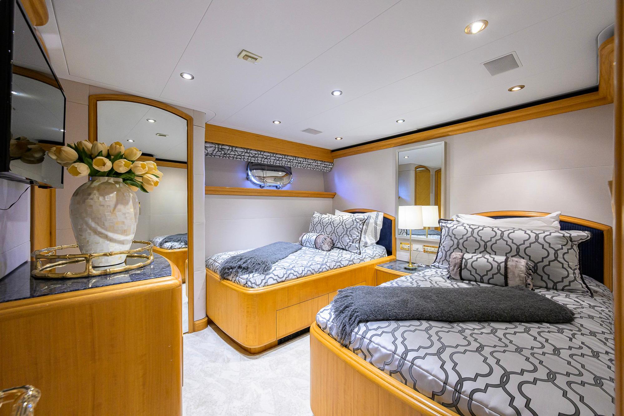 Luxurious 2003 Cheoy Lee Trideck yacht bedroom with twin beds and elegant decor.