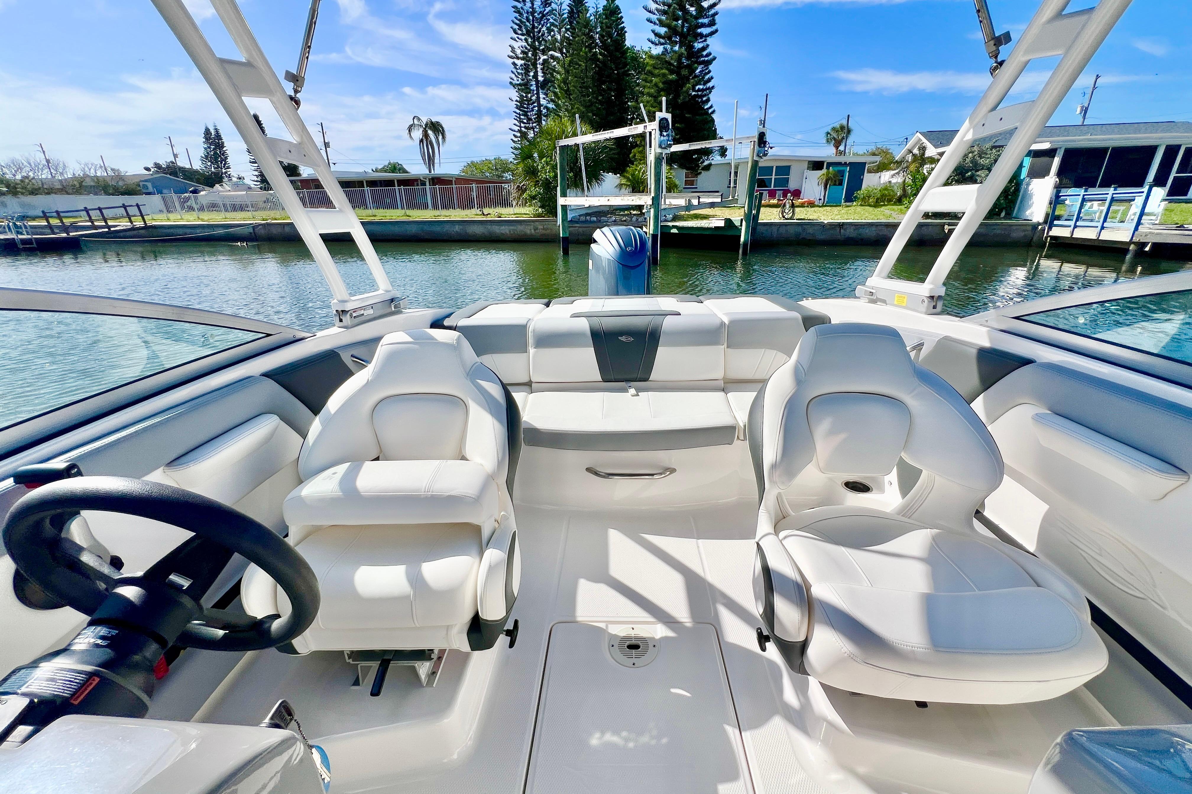 2023 Chaparral 21 SSi OB boat interior with white seating and steering wheel.
